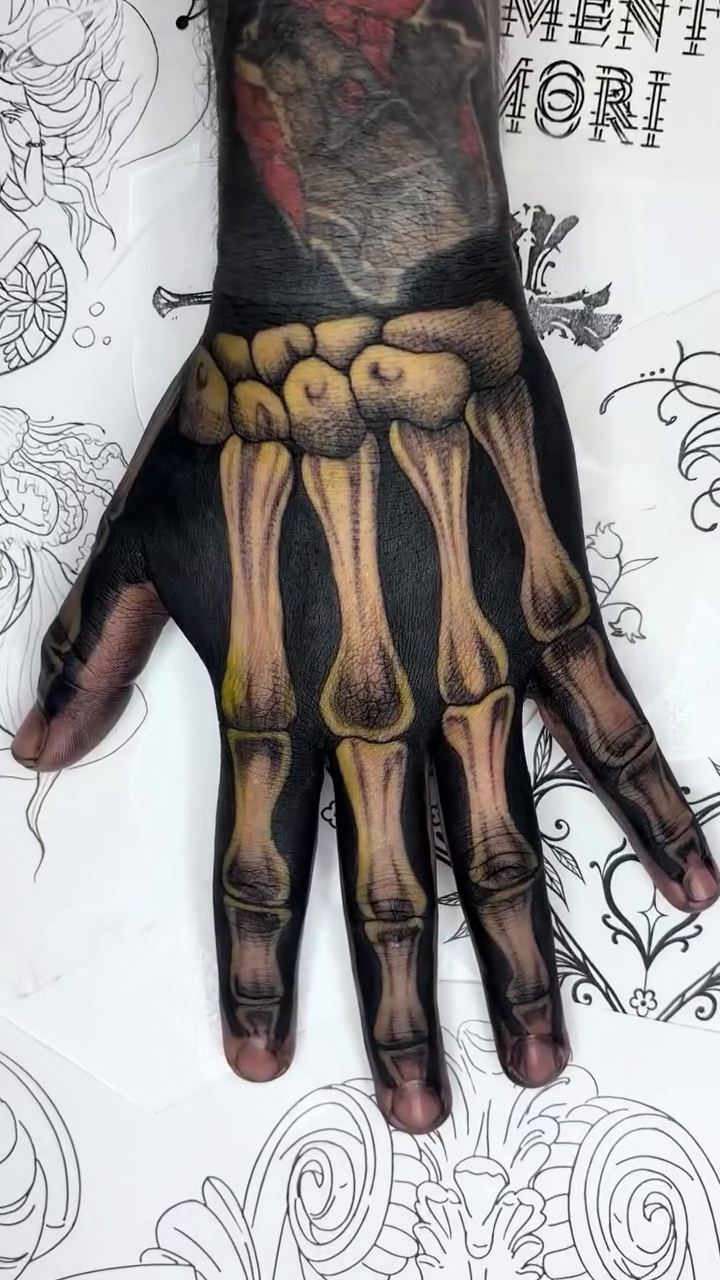 Skeleton hand tattoo dark art tattoo on the hand by Weho Tattoo Artist Lupe