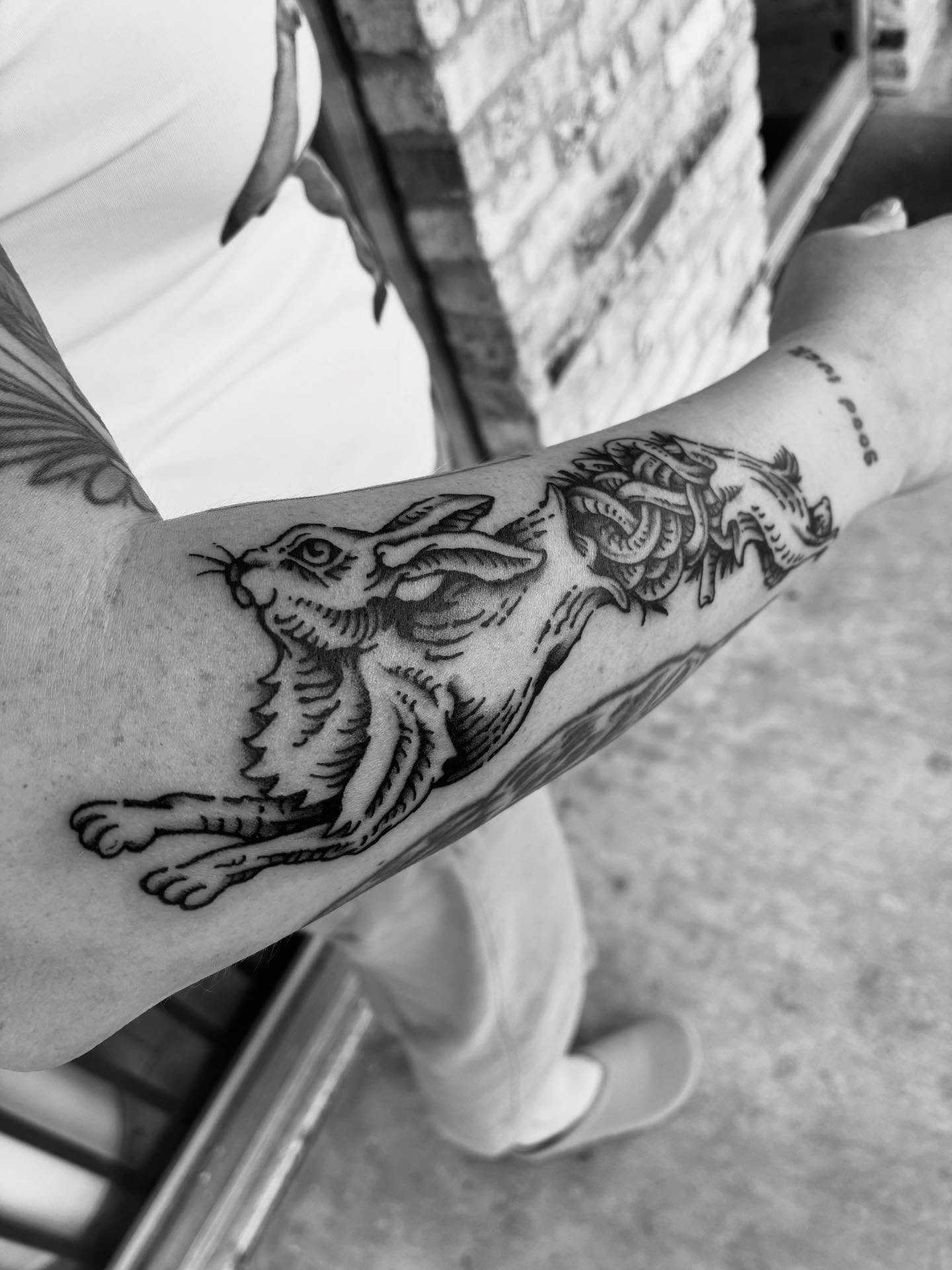 Hare and dragon American traditional tattoo on the forearm by Zachary R Bobkoff