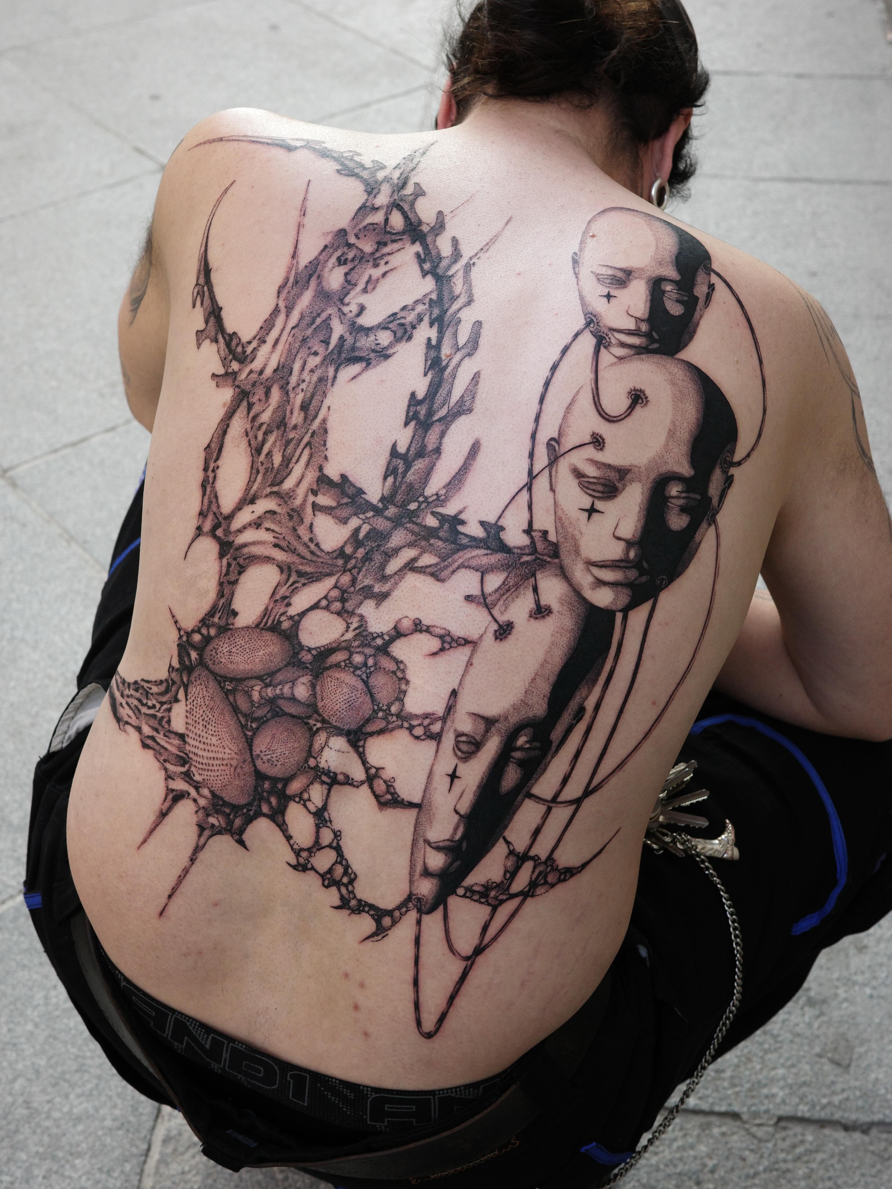 Abstract surrealism surrealism tattoo on the back by Sophia Tattoo