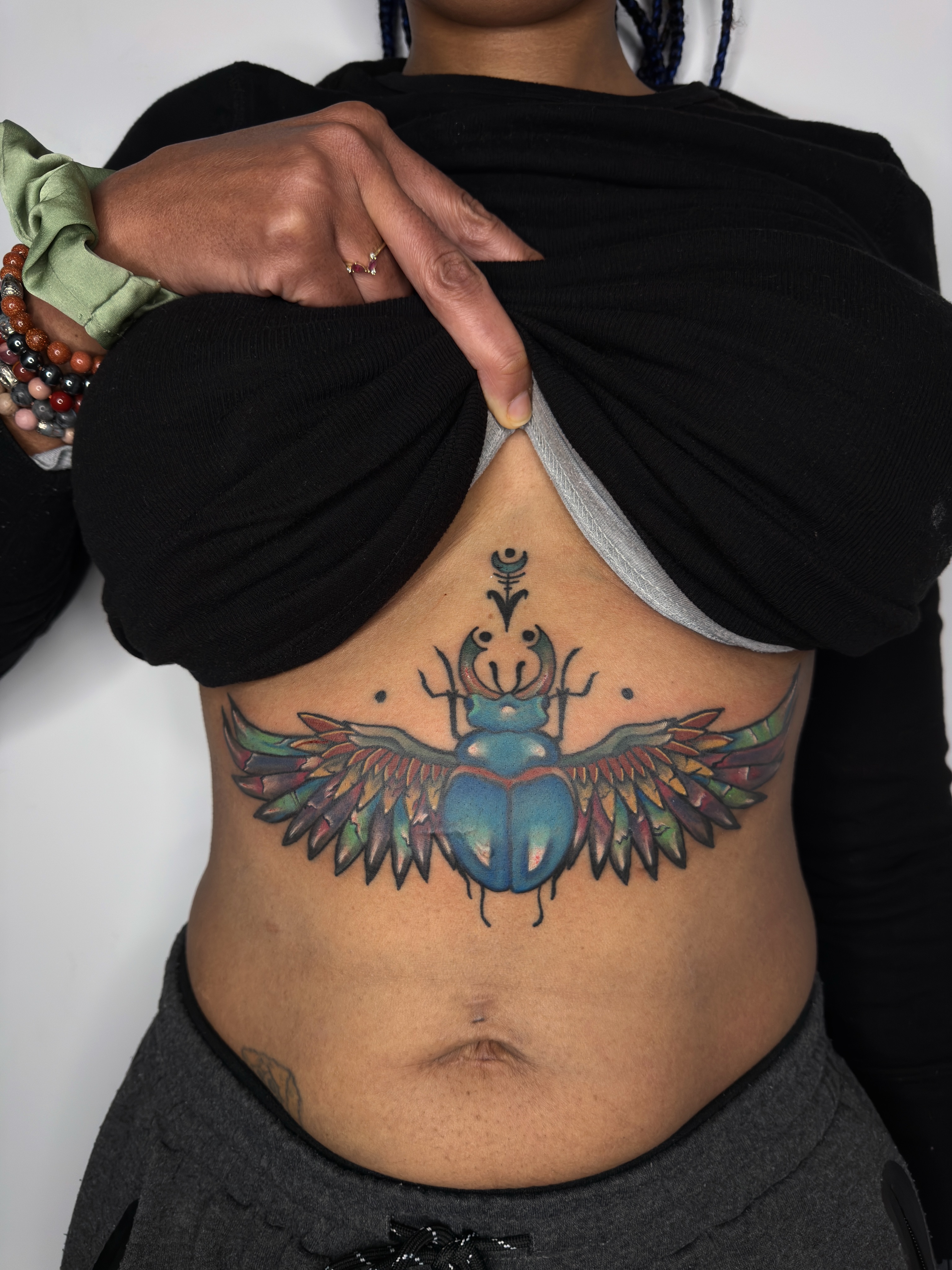 Scarab beetle new school tattoo on the ribs by Joshua Carter