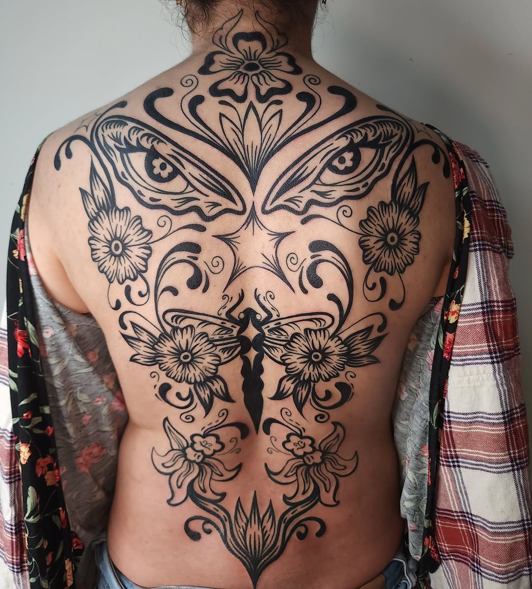 Floral butterfly ornamental tattoo on the back by Maxine Stewart