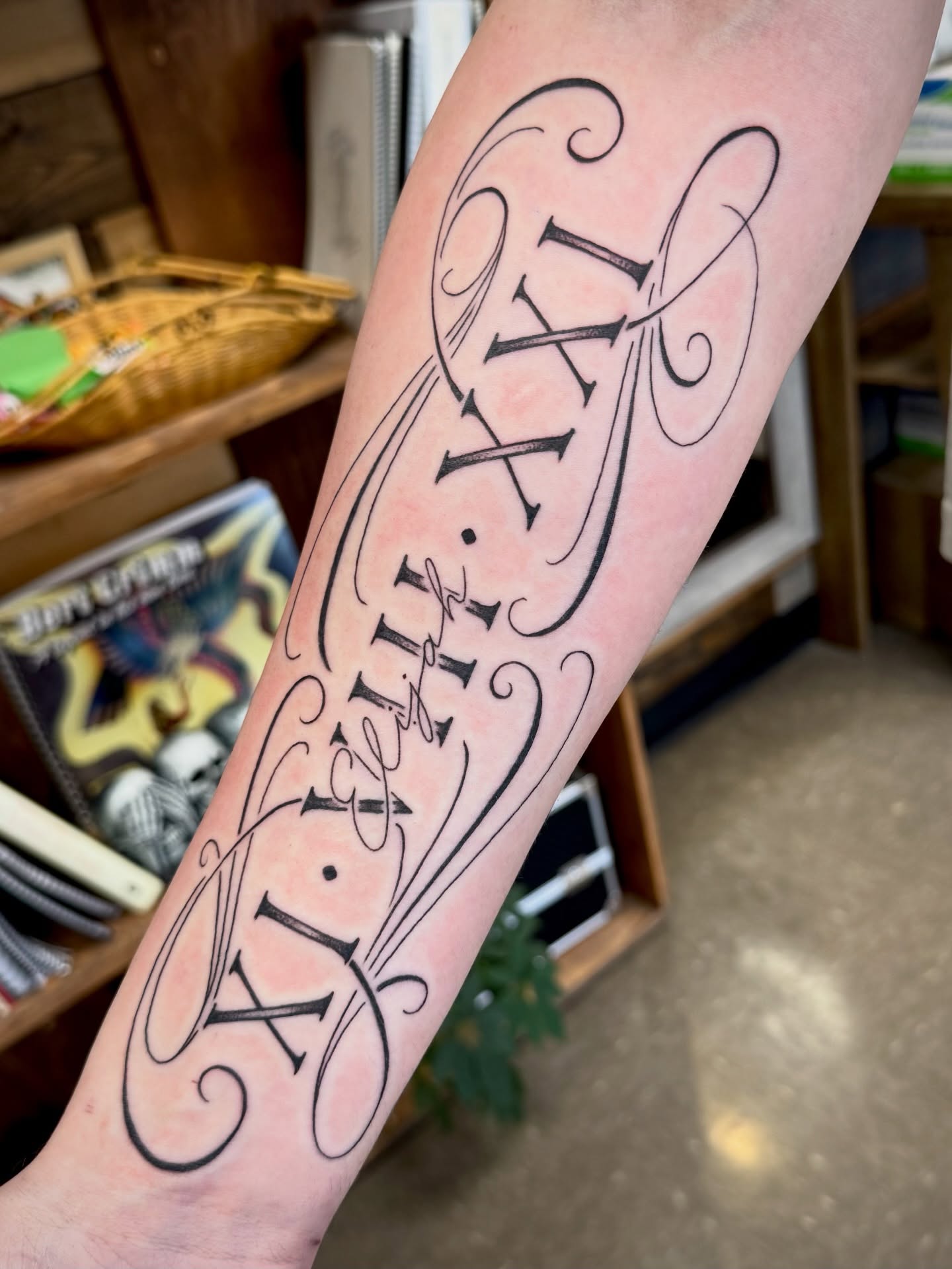 Roman numerals lettering script tattoo on the forearm by Samantha Jane