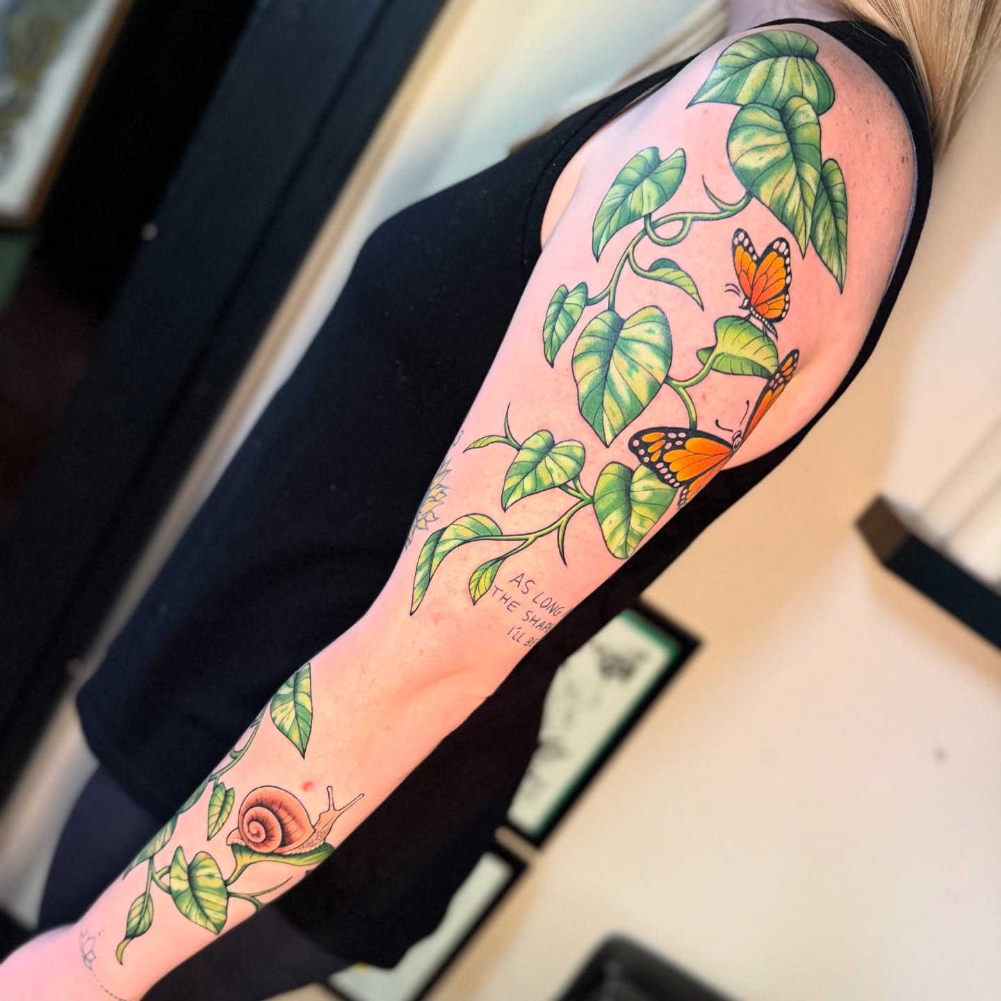 Monarch butterflies and leaves new school tattoo on the upper arm by Chelstine, Encinitas, California