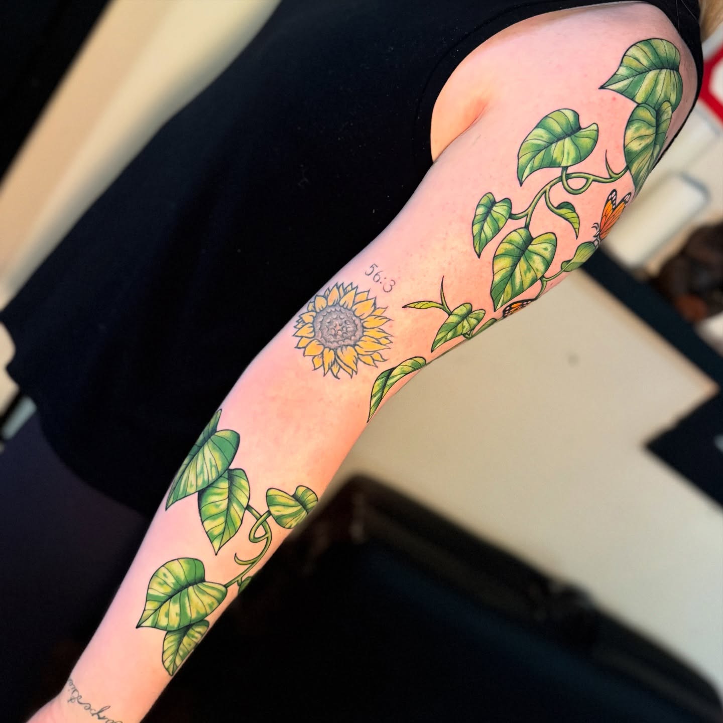 Sunflower and leaves new school tattoo on the forearm by Chelstine, Encinitas, California