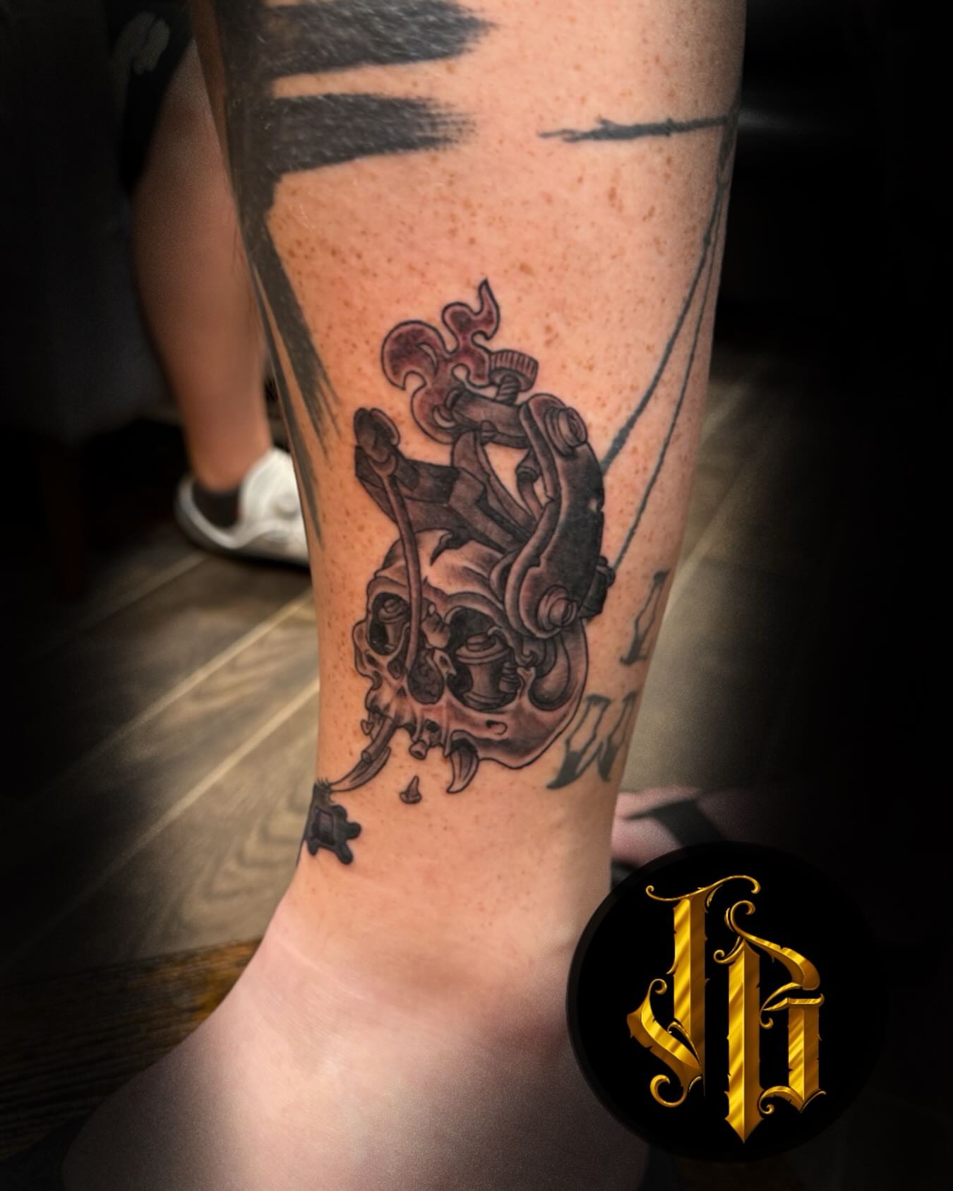 Skull and mechanical parts realism tattoo on the forearm by James Brooks