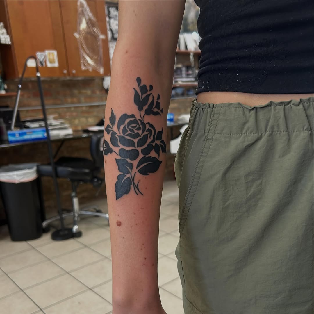 Rose and leaves ornamental tattoo on the forearm by Elizabeth Niederkorn