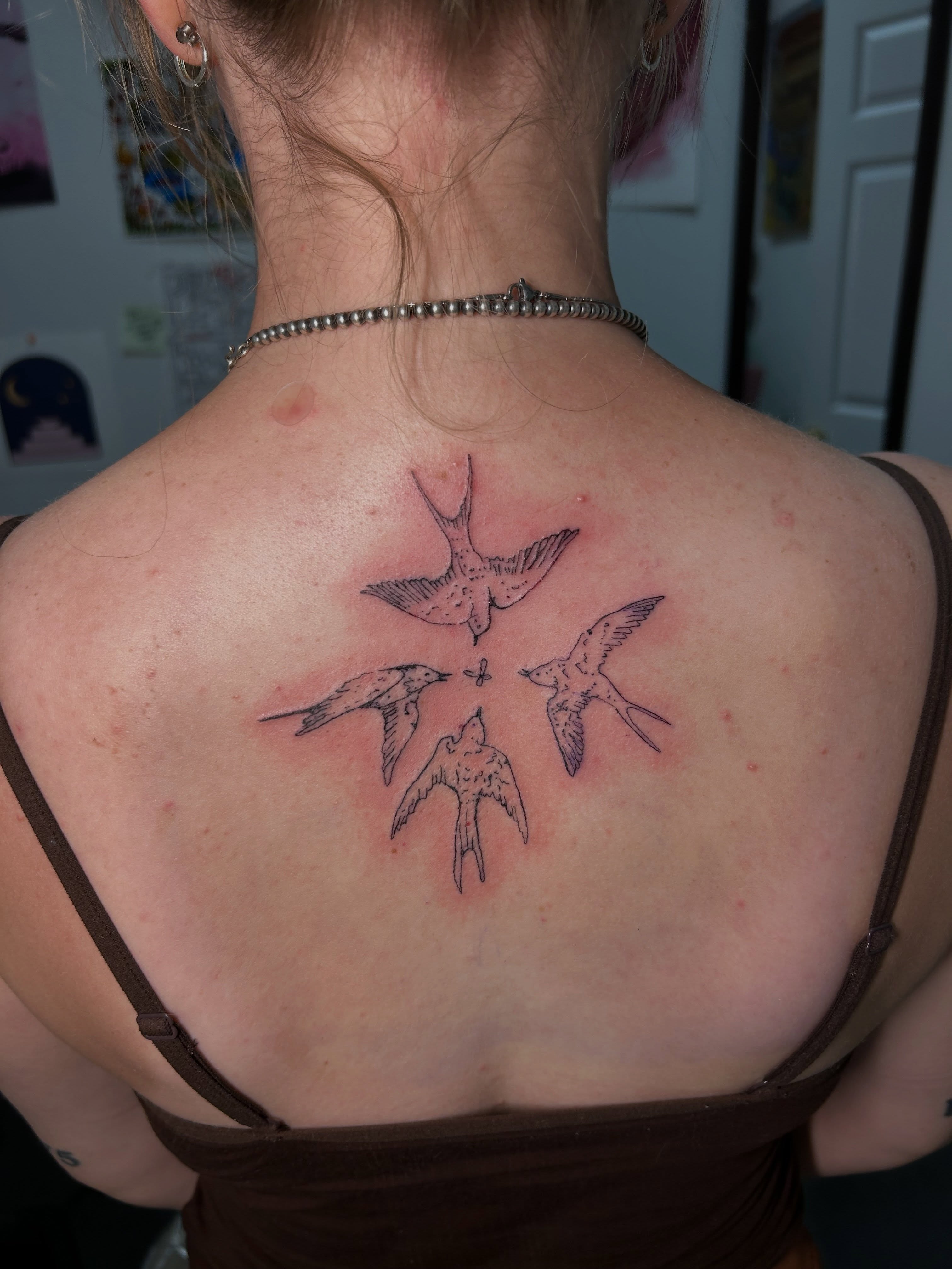 Swallows black and grey tattoo on the back by Mattie Robinson