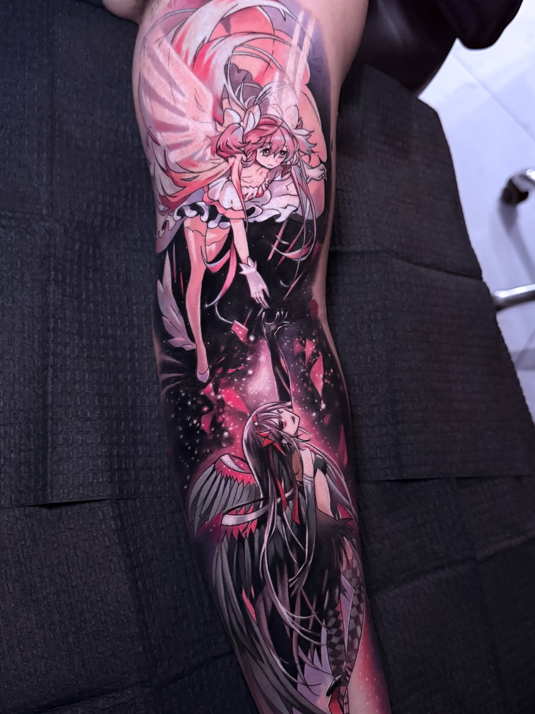 Two anime characters in space anime tattoo on the forearm by Alex Moro