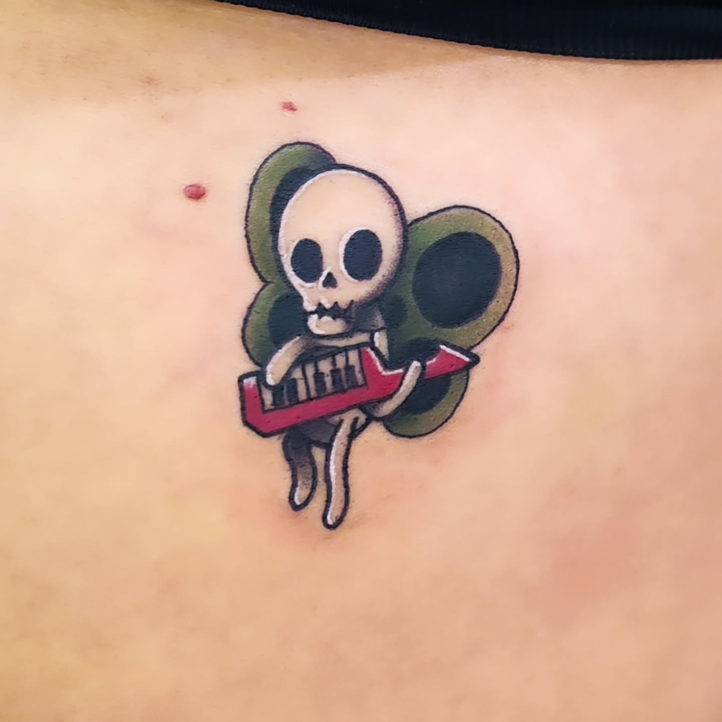 Skull playing keyboard American traditional tattoo on the torso by Amanda Boyd - Duh!
