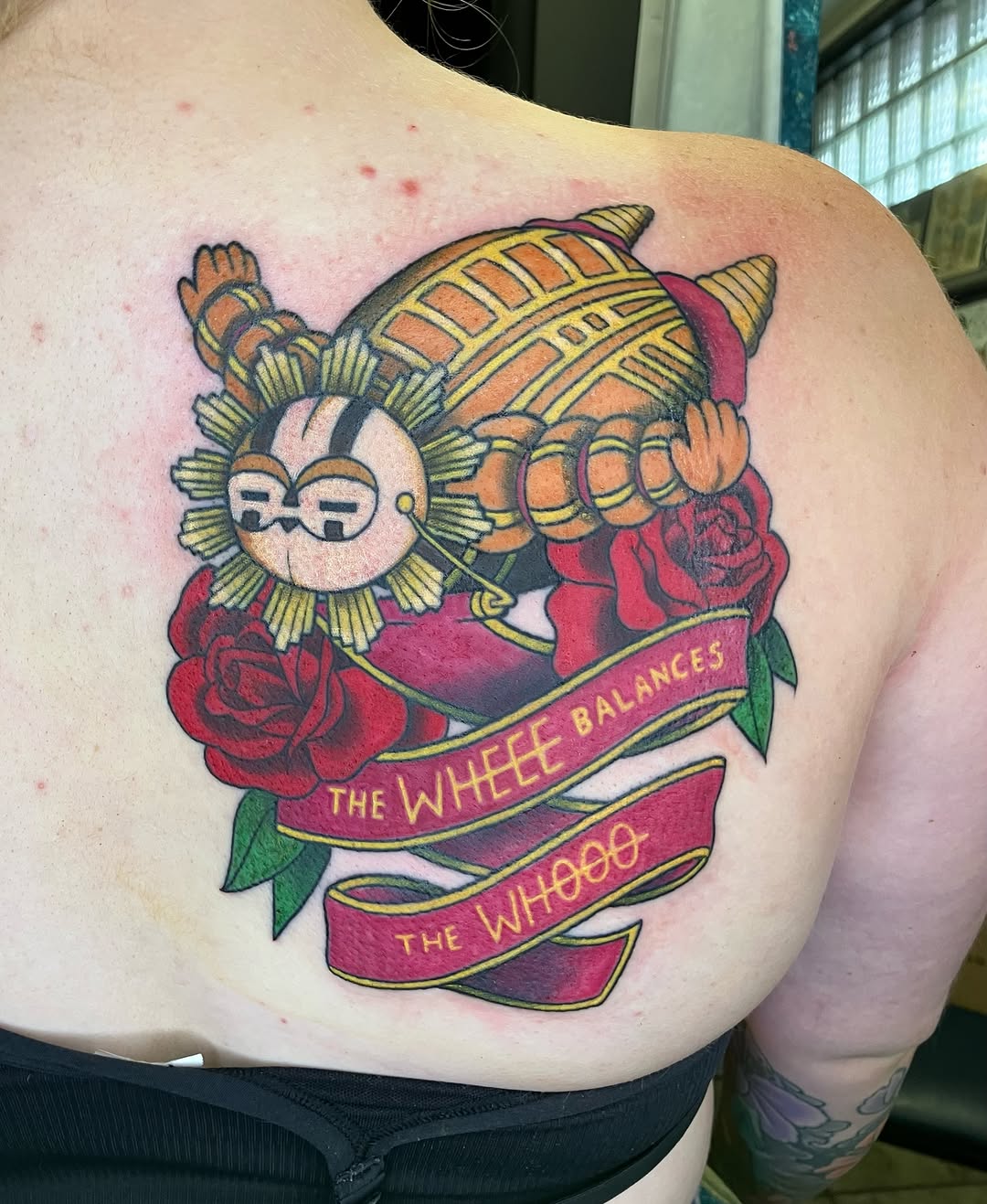 Character with banner and roses tattoo on the shoulder by maddie mcghee, Memphis, Tennessee