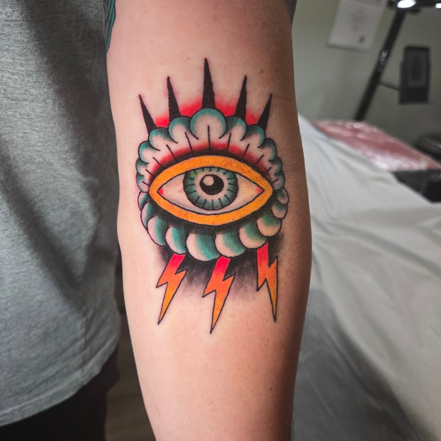 Eye with lightning bolts American traditional tattoo on the forearm by Matt Page