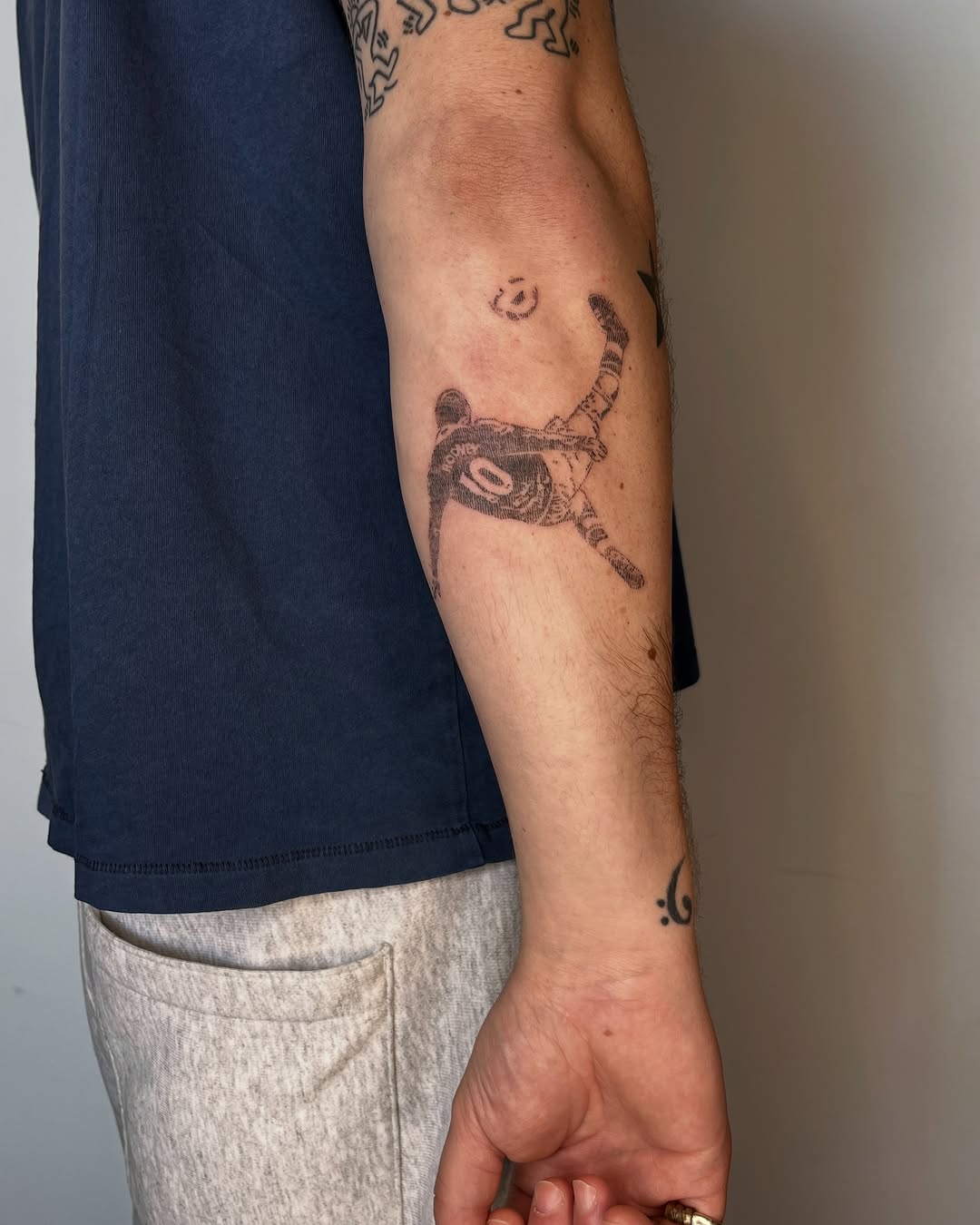 Football player kicking ball minimalist tattoo on the forearm by Gap⋆head