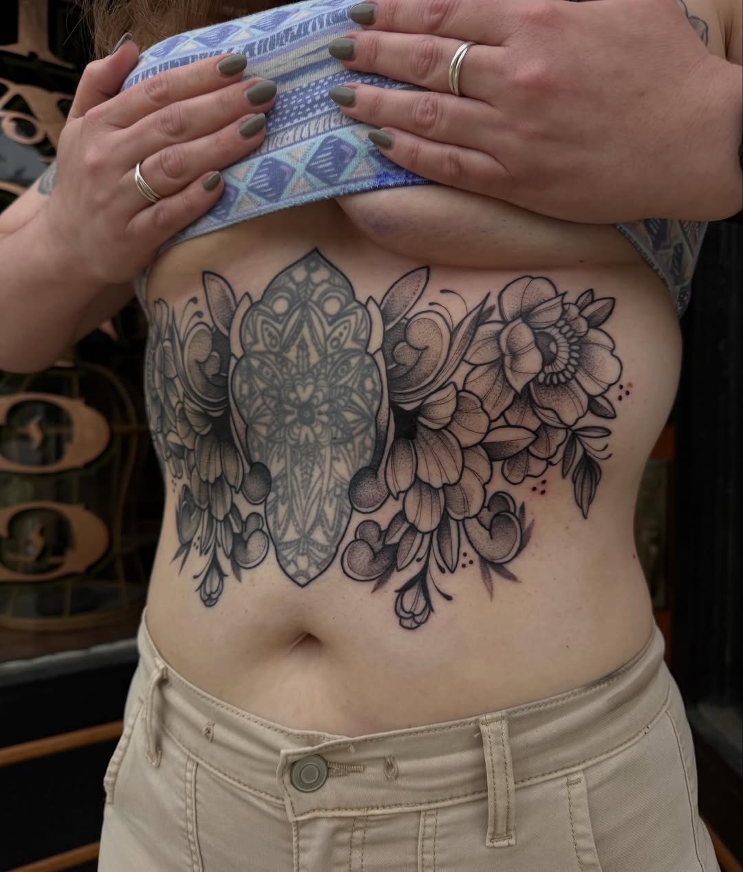 Floral mandala ornamental tattoo on the ribs by Allison