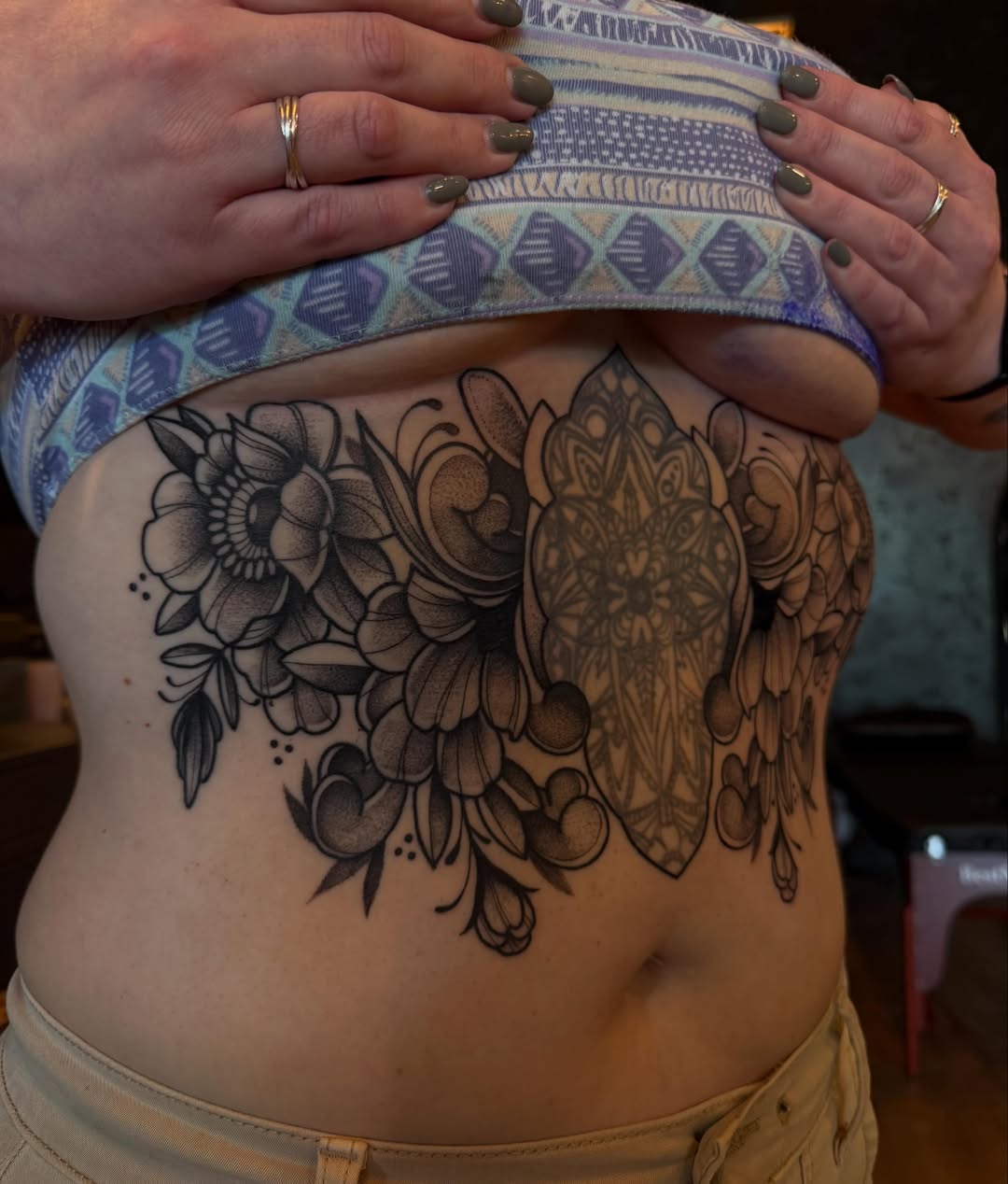 Floral mandala geometric tattoo on the torso by Allison