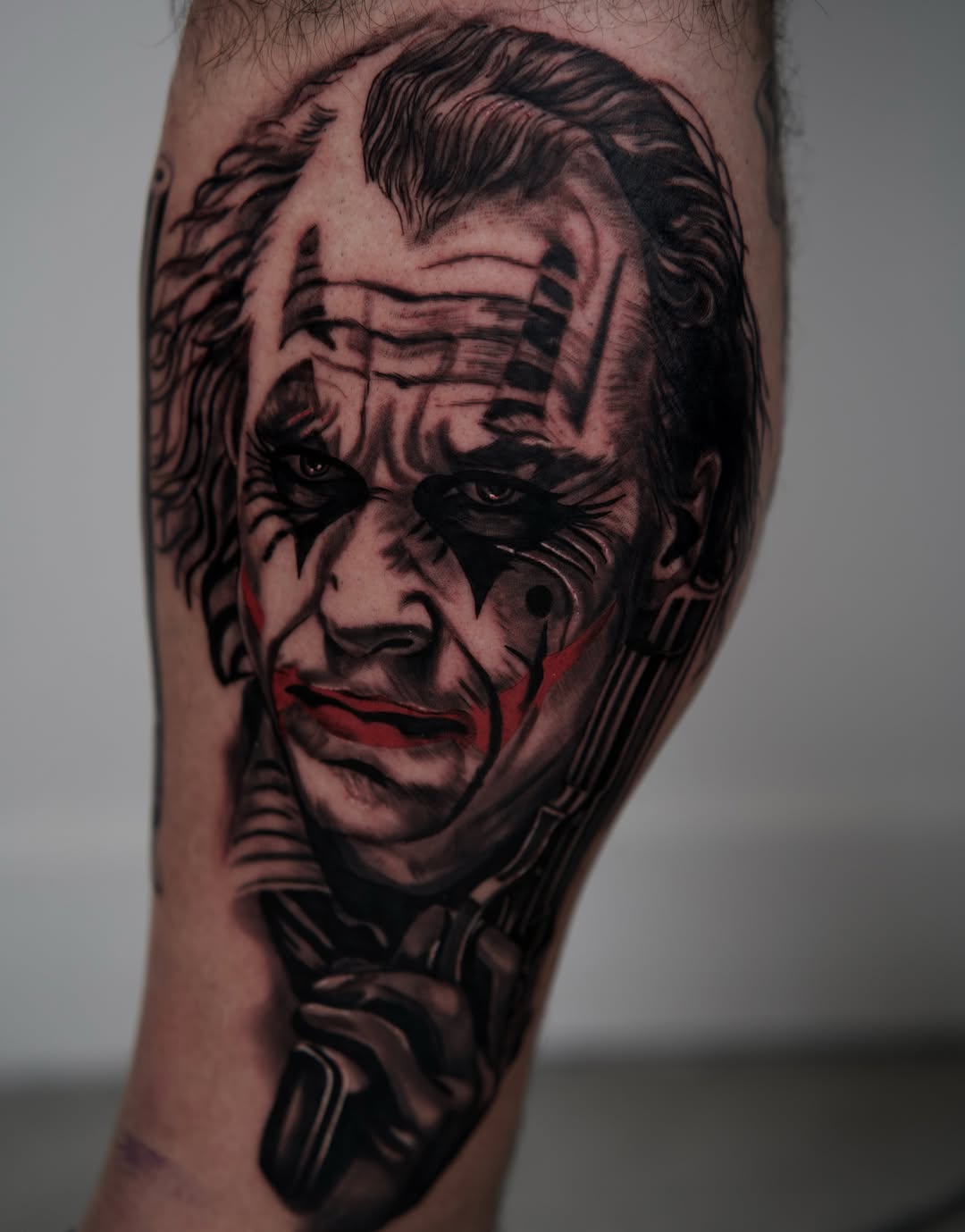 The Joker portrait realism tattoo on the forearm by Travis