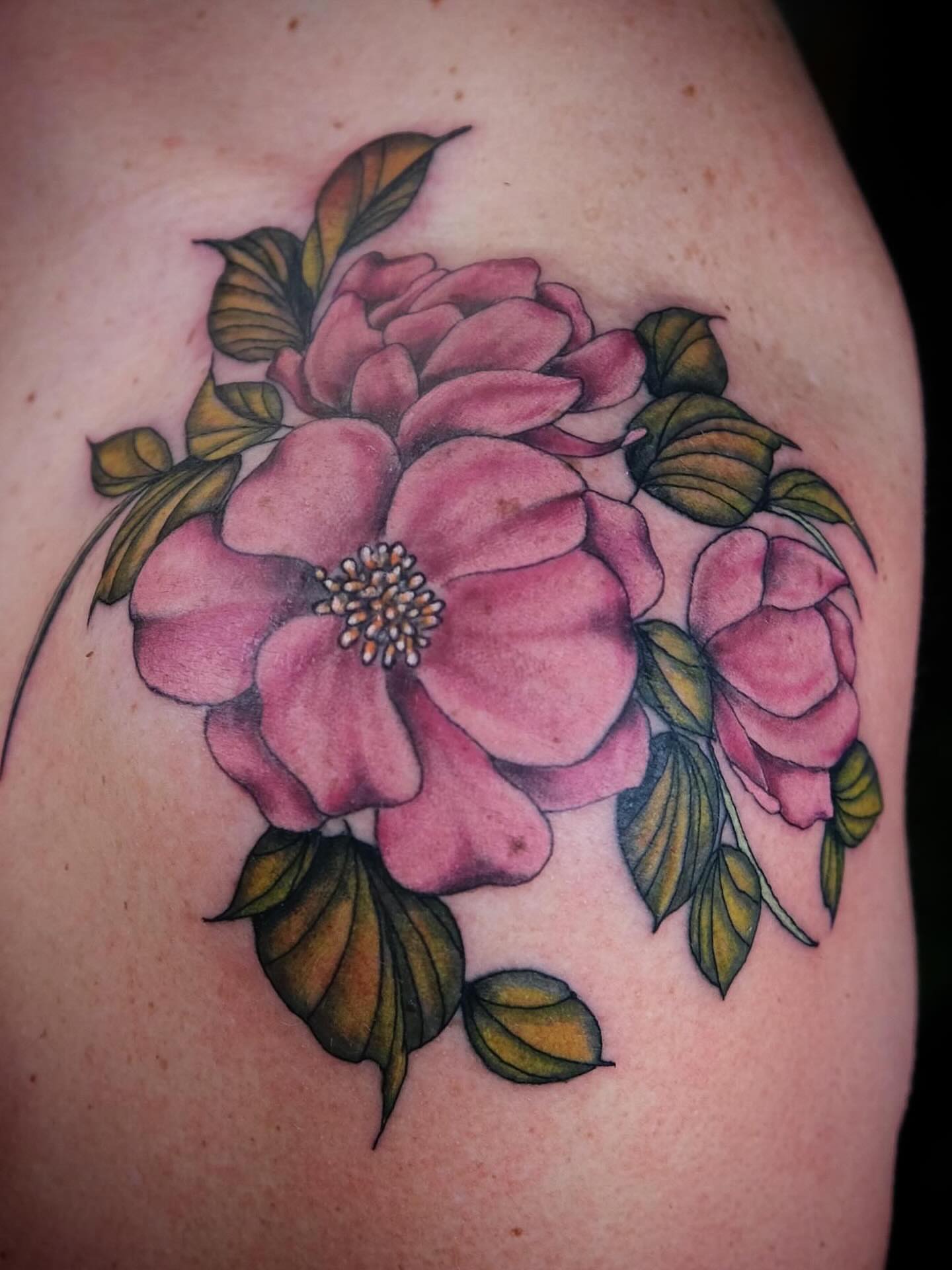 Pink flowers realism tattoo on the shoulder by Suzanne B