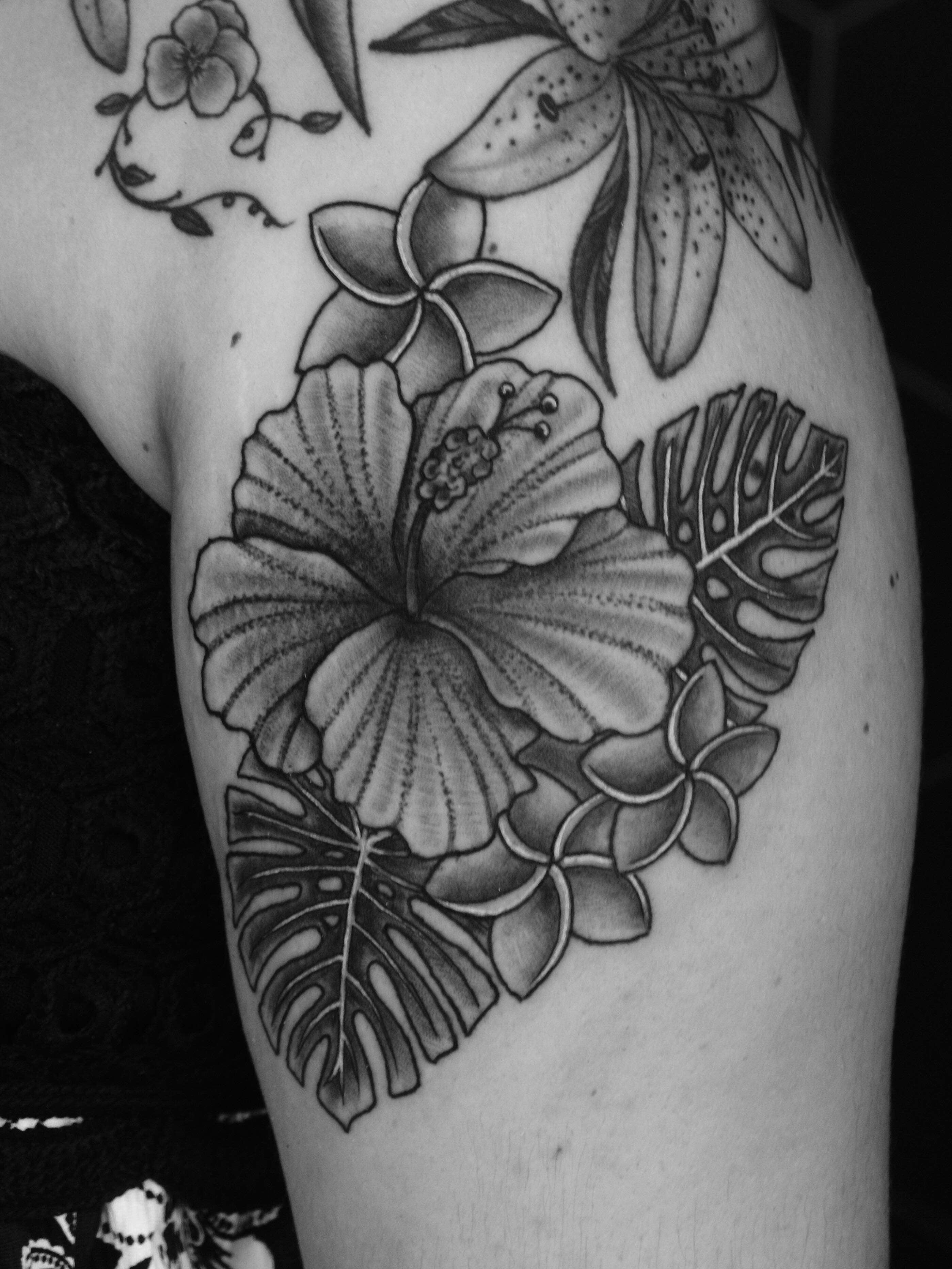 Tropical floral arrangement realism tattoo on the thigh by Suzanne B