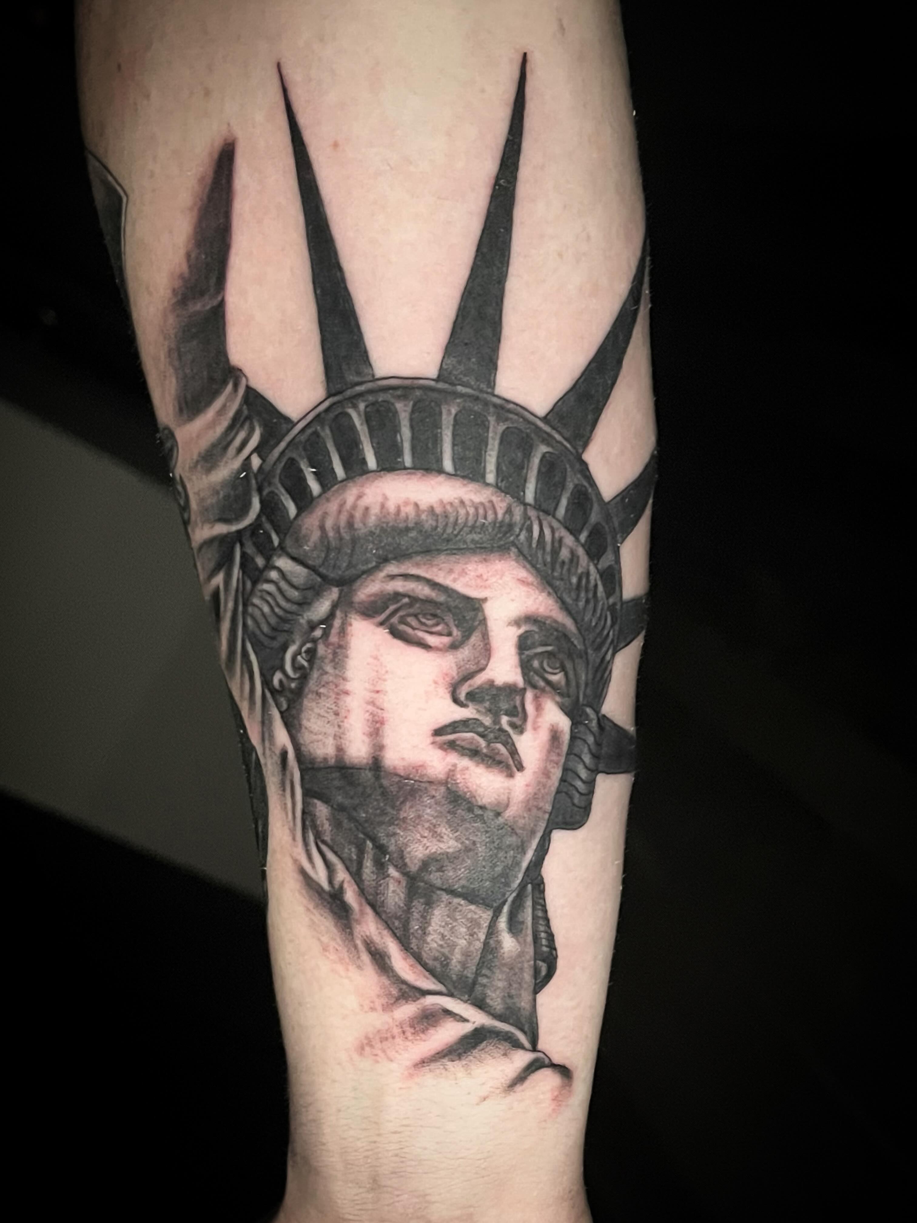 Statue of liberty realism tattoo on the forearm by Suzanne B