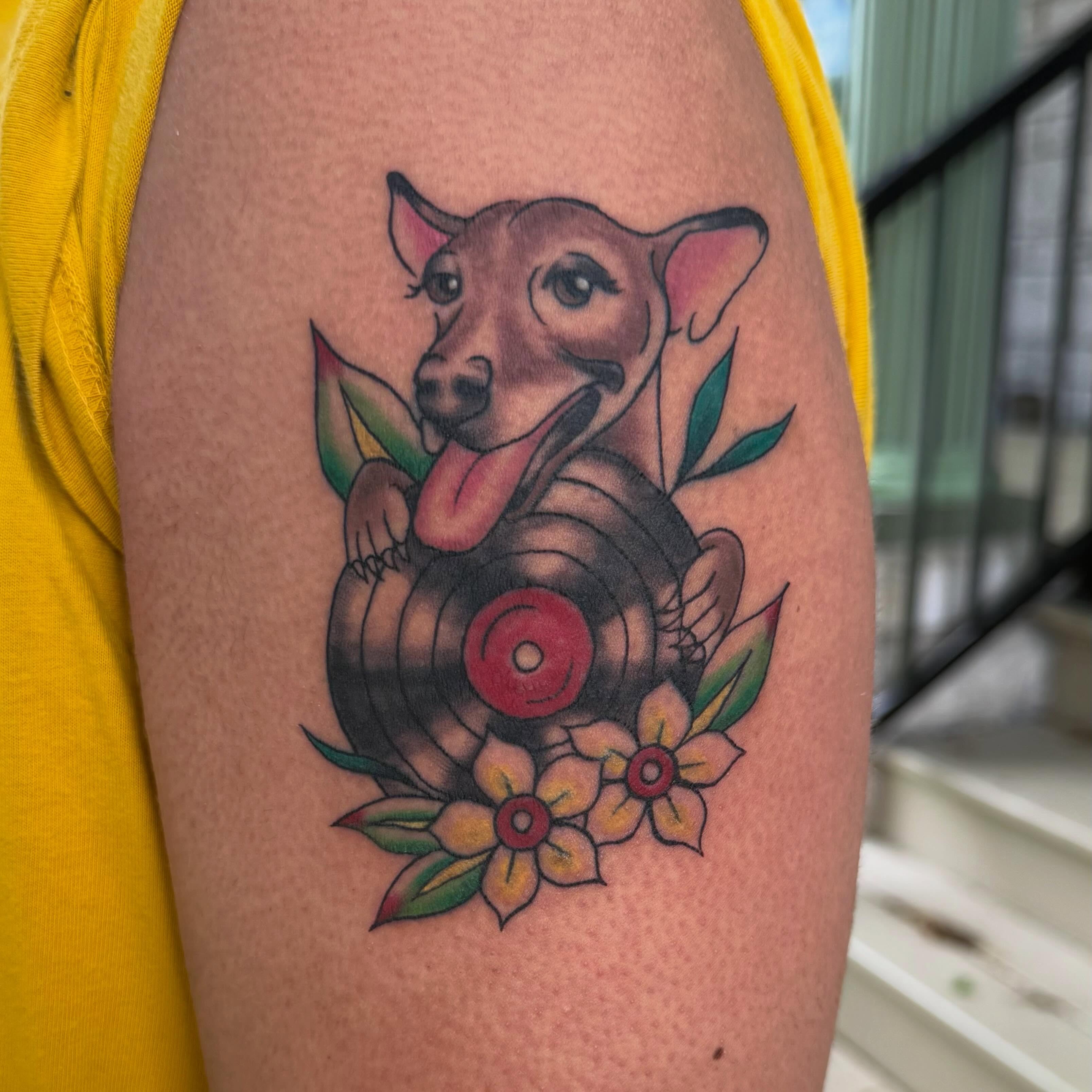 Dog with record American traditional tattoo on the forearm by sarah