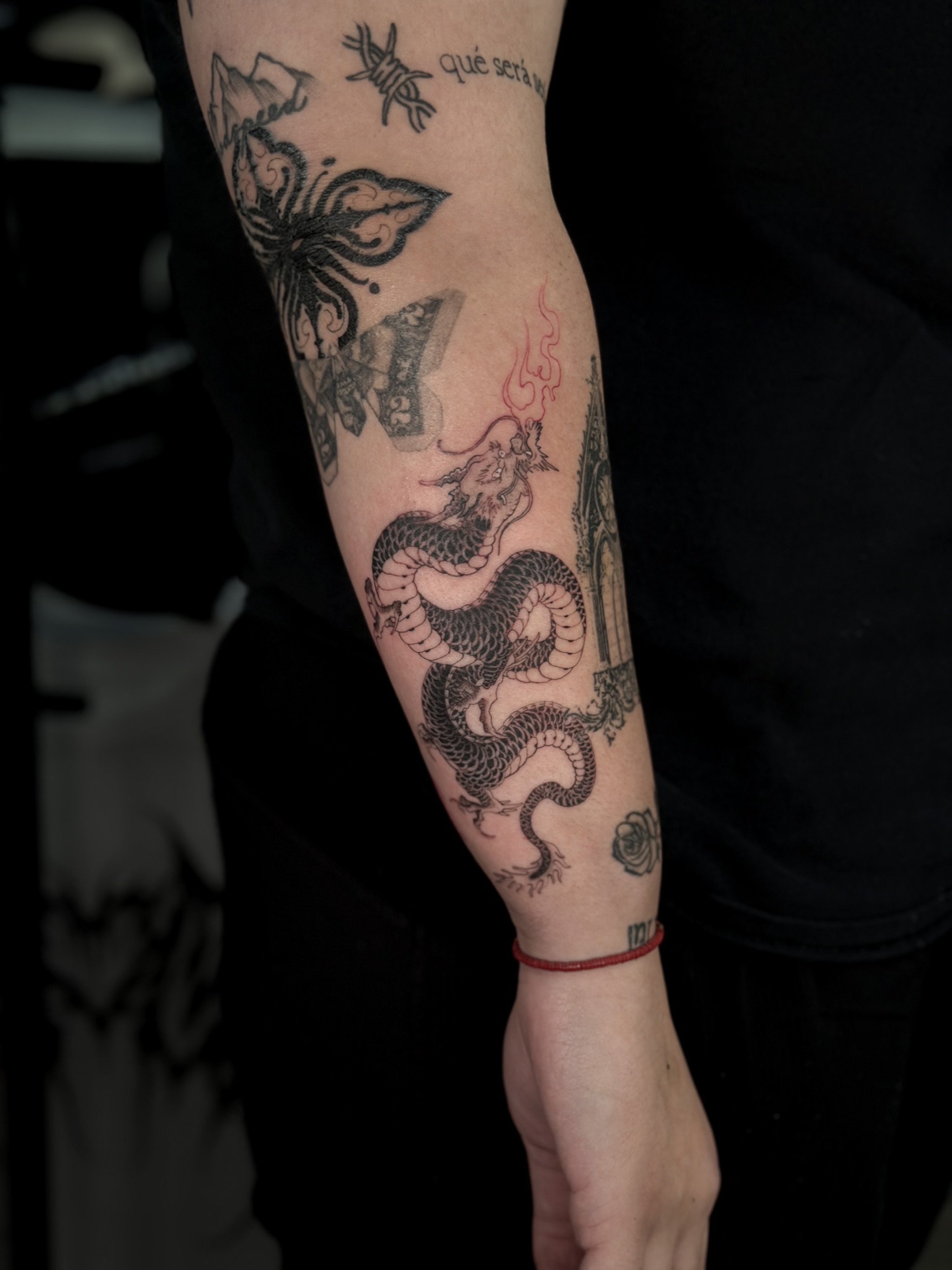 Dragon and temple black and grey tattoo on the forearm by Elijah Cosme, Miami, Florida