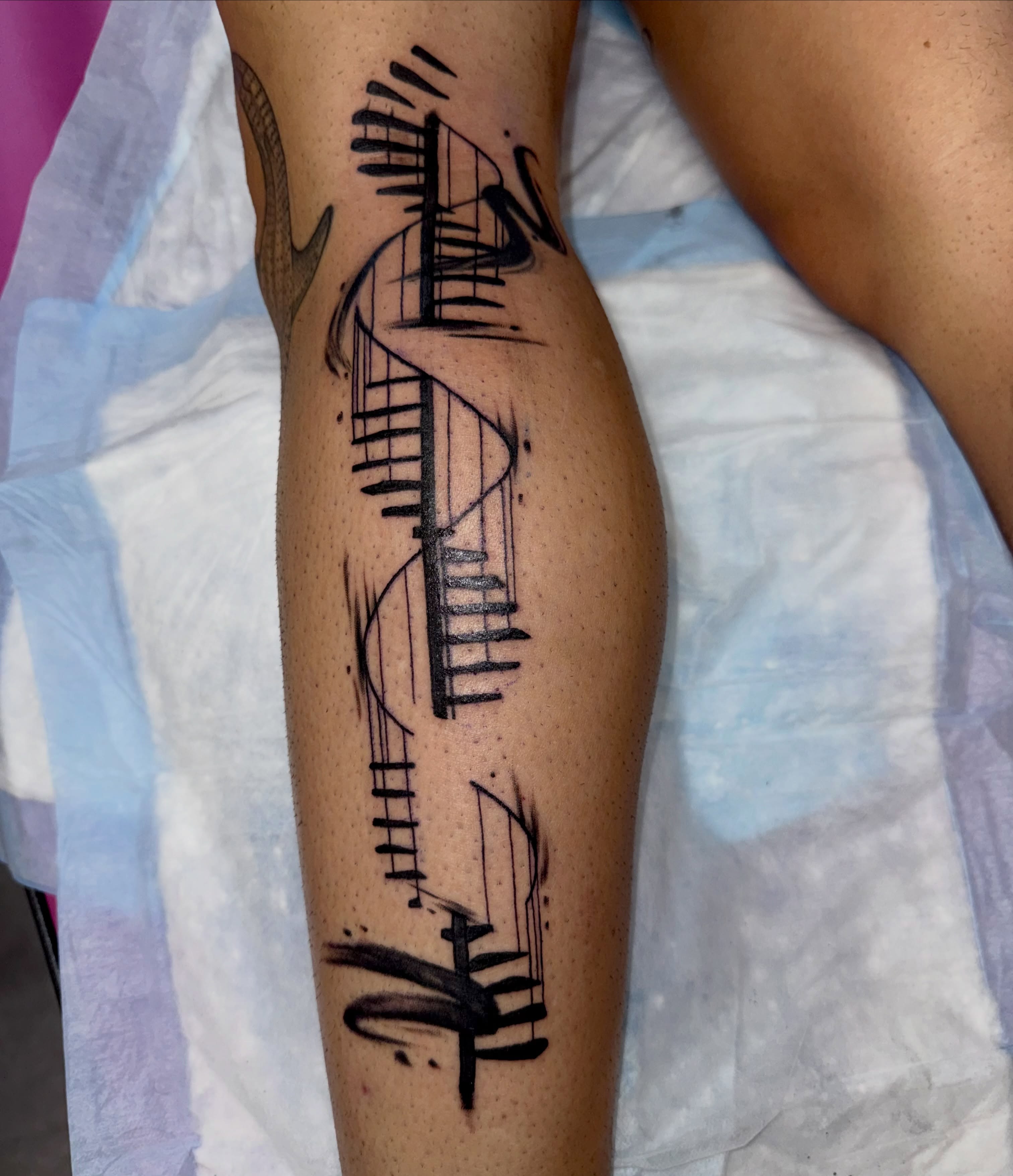 Abstract musical notes black and grey tattoo on the leg by Caitlynn Austin
