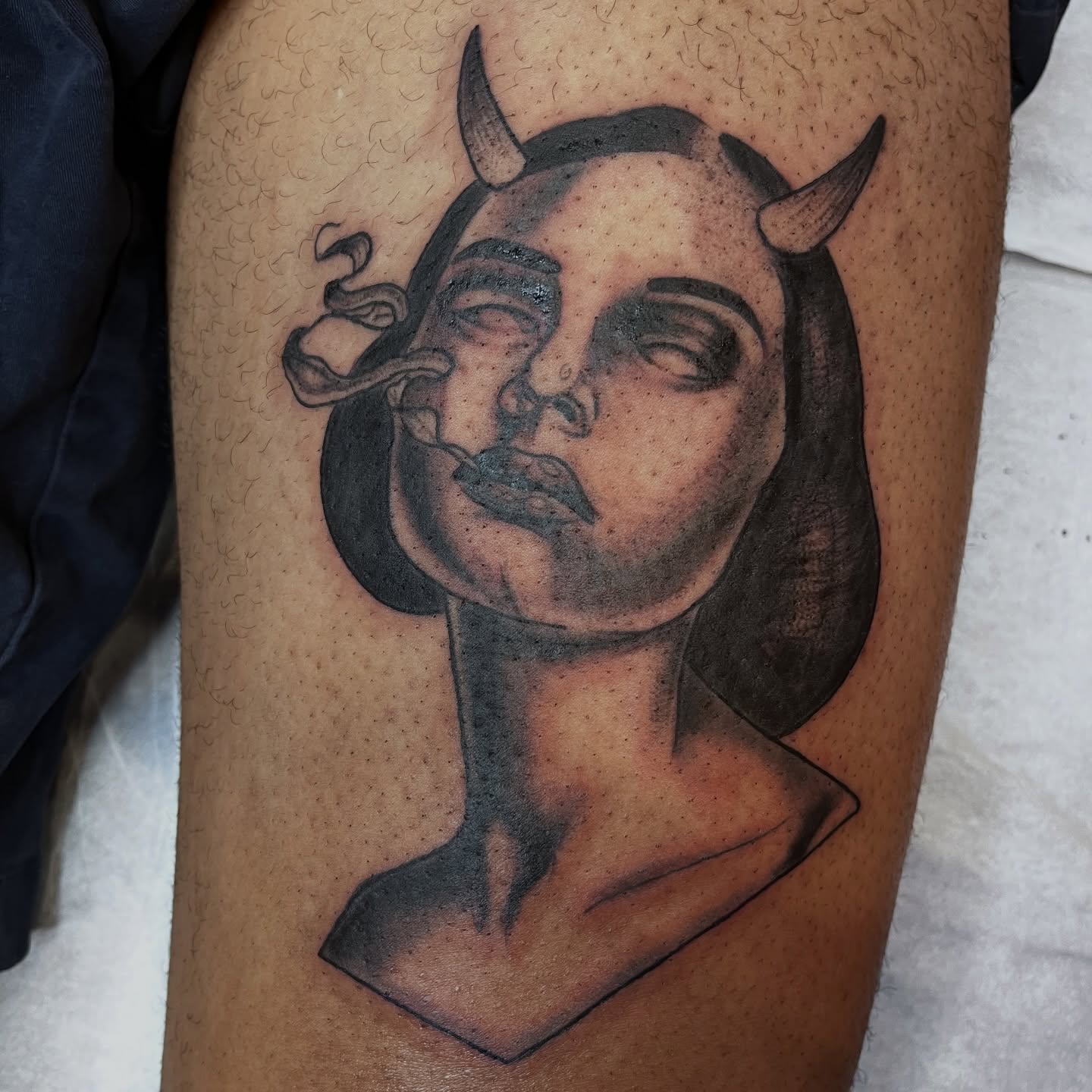 Woman with horns black and grey tattoo on the thigh by Misha Dumois, Seattle, Washington