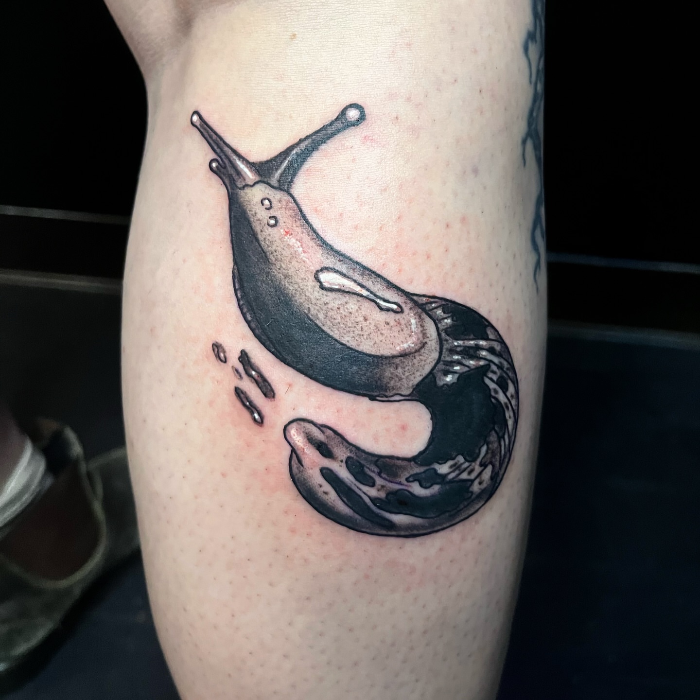 Snail realism tattoo on the forearm by Misha Dumois, Seattle, Washington