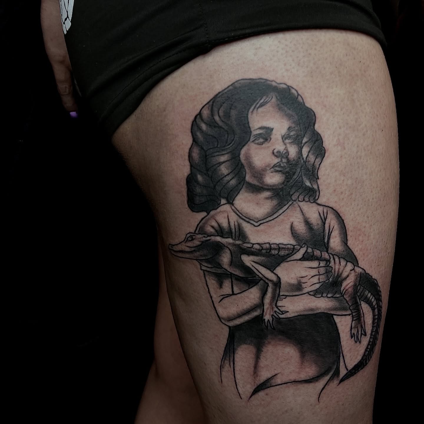 Girl with crocodile realism tattoo on the thigh by Misha Dumois, Seattle, Washington