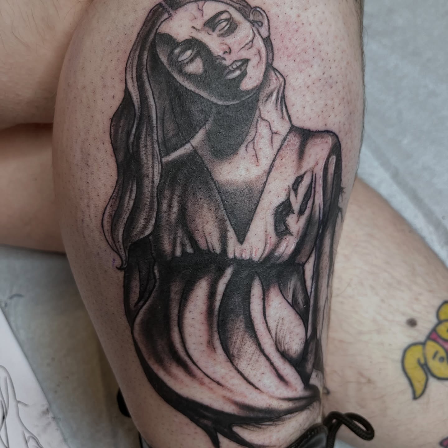 Woman in robe black and grey tattoo on the thigh by Misha Dumois, Seattle, Washington