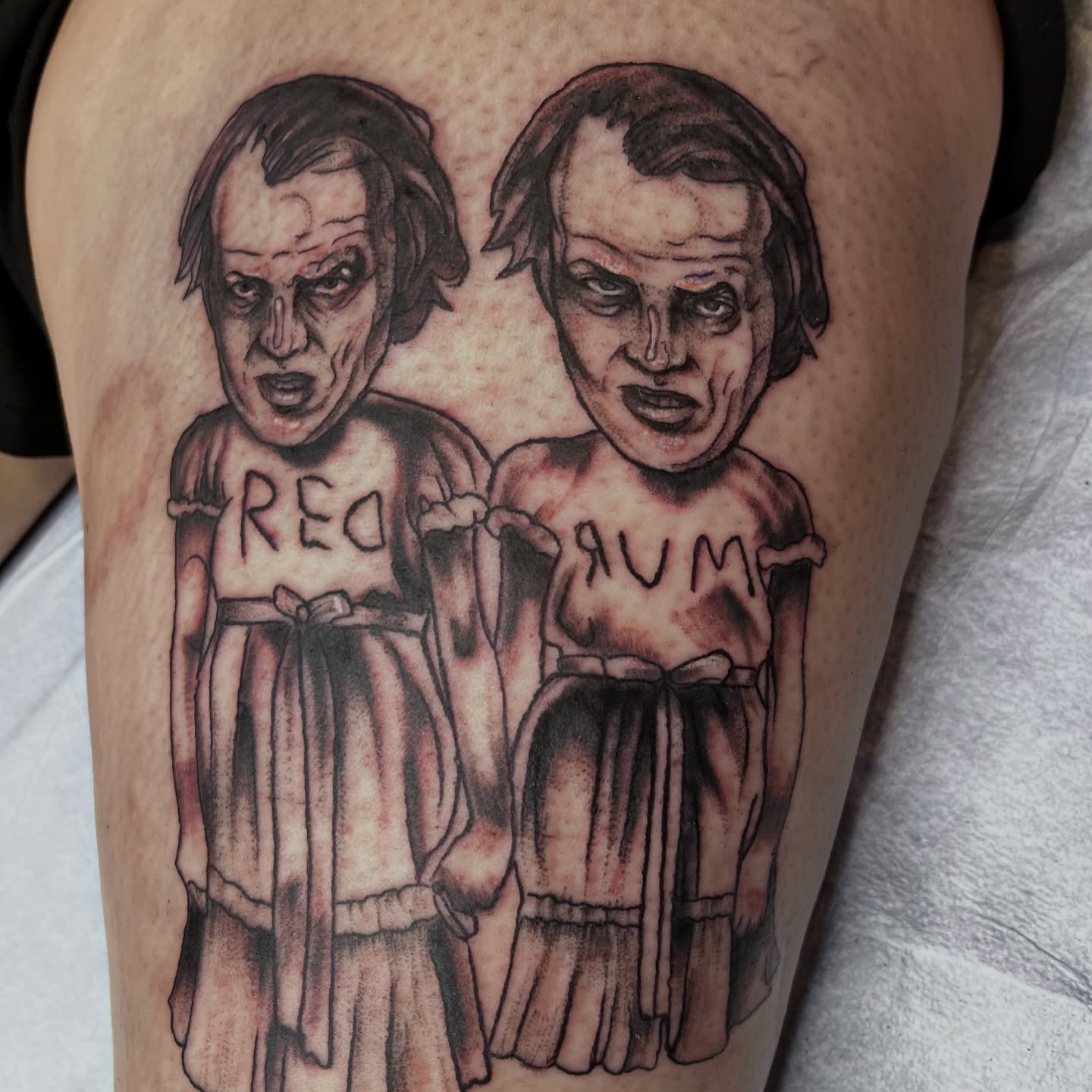 Twins black and grey tattoo on the thigh by Misha Dumois, Seattle, Washington