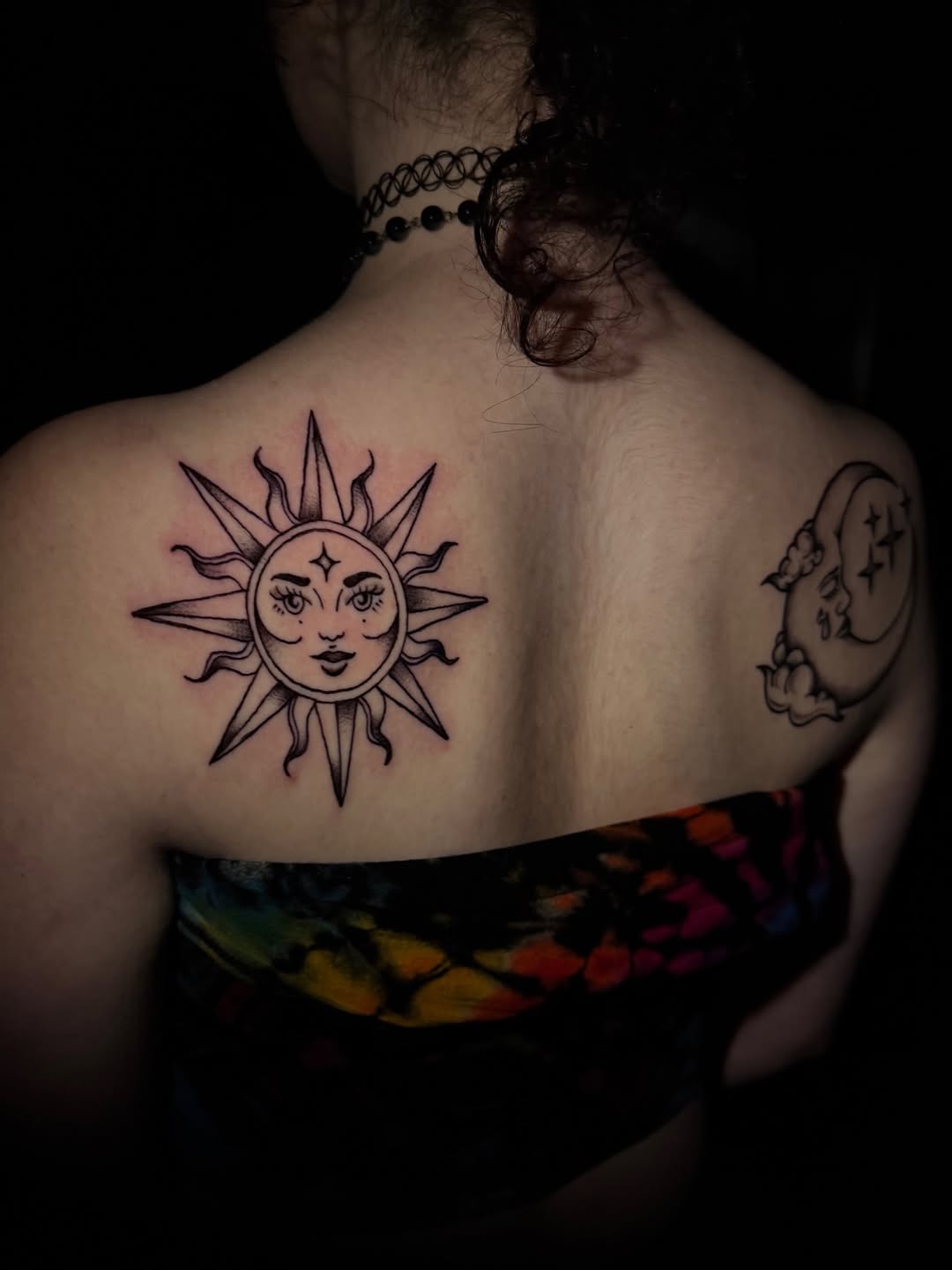 Sun face and moon geometric tattoo on the back by licensed charlotte tattoo artist