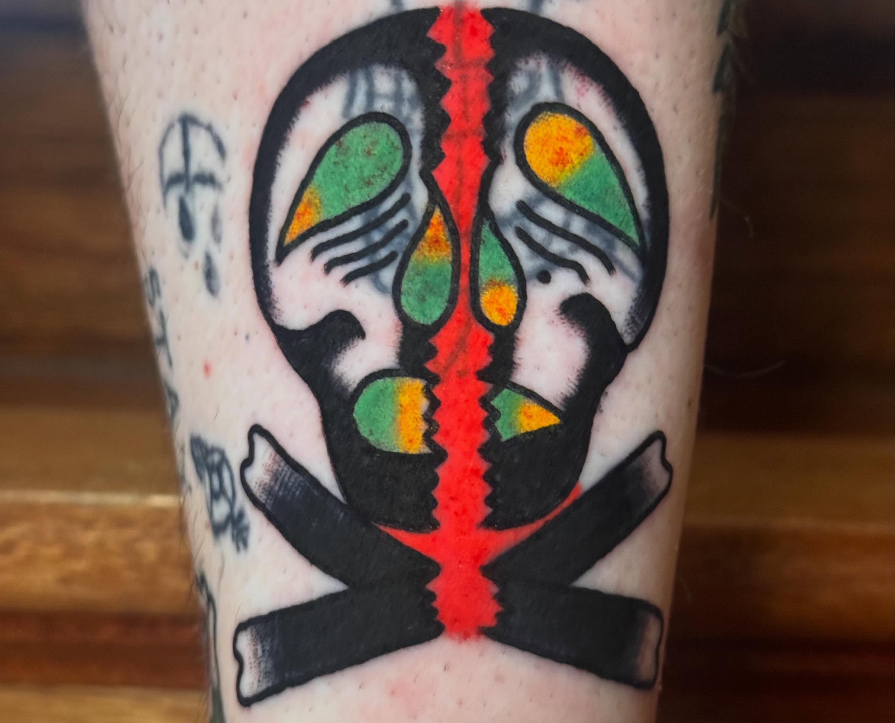 Mask American traditional tattoo on the forearm by Zach Lemieux