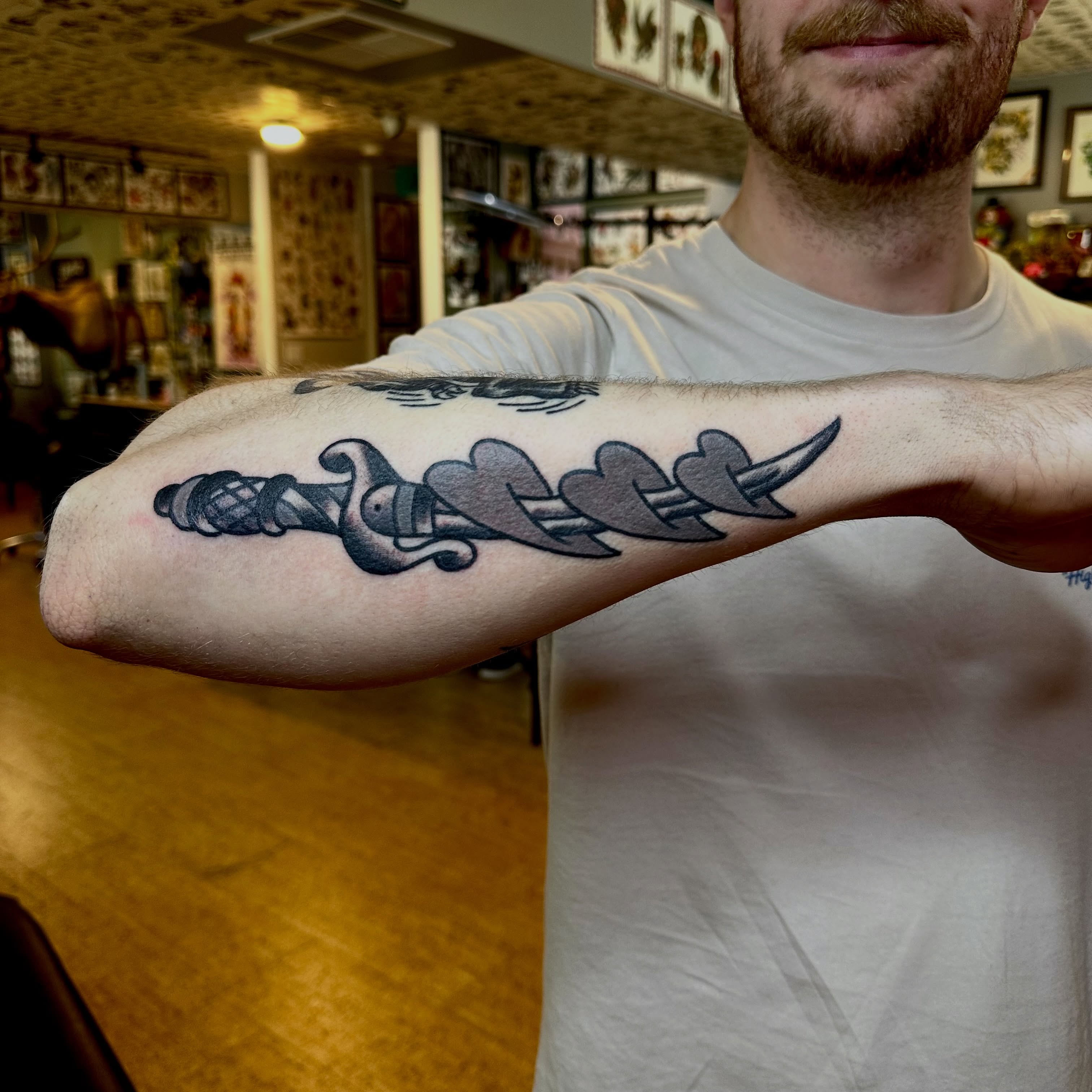 Sword and arrows black and grey tattoo on the forearm by teddy, Portland, Oregon