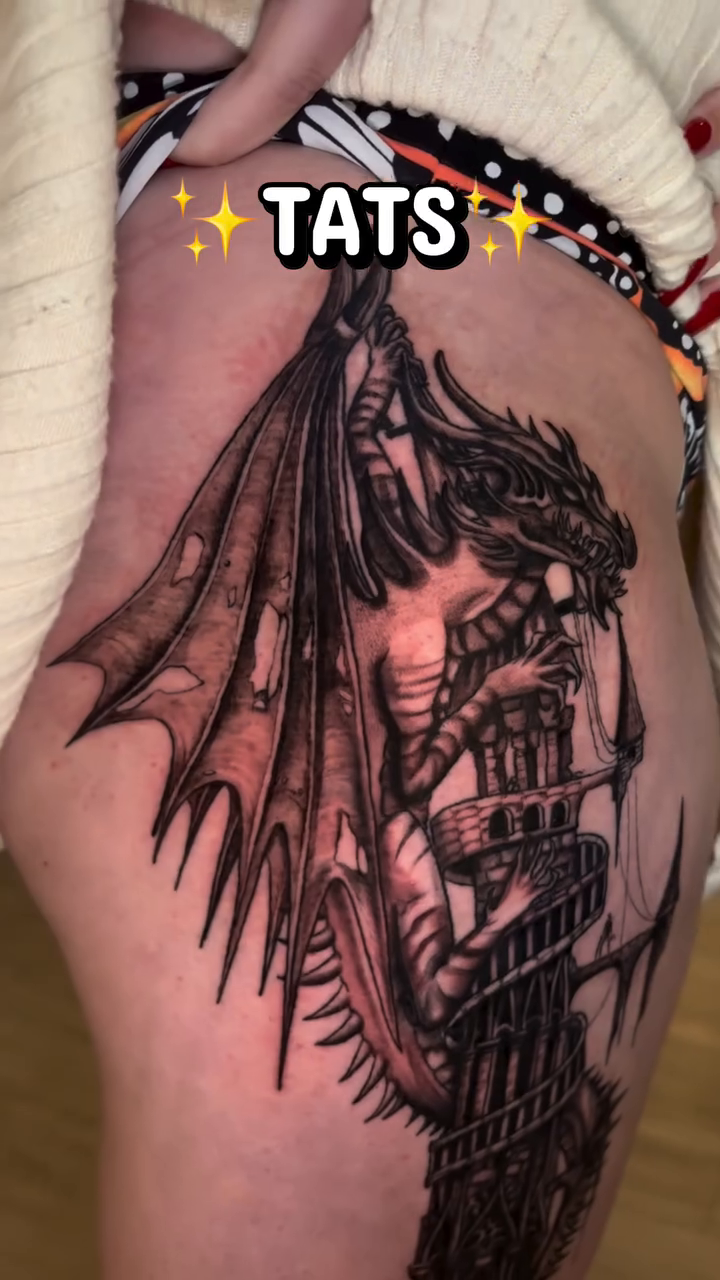 Dragon on a tower blackwork tattoo on the upper arm by Kiwi🌱☀️
