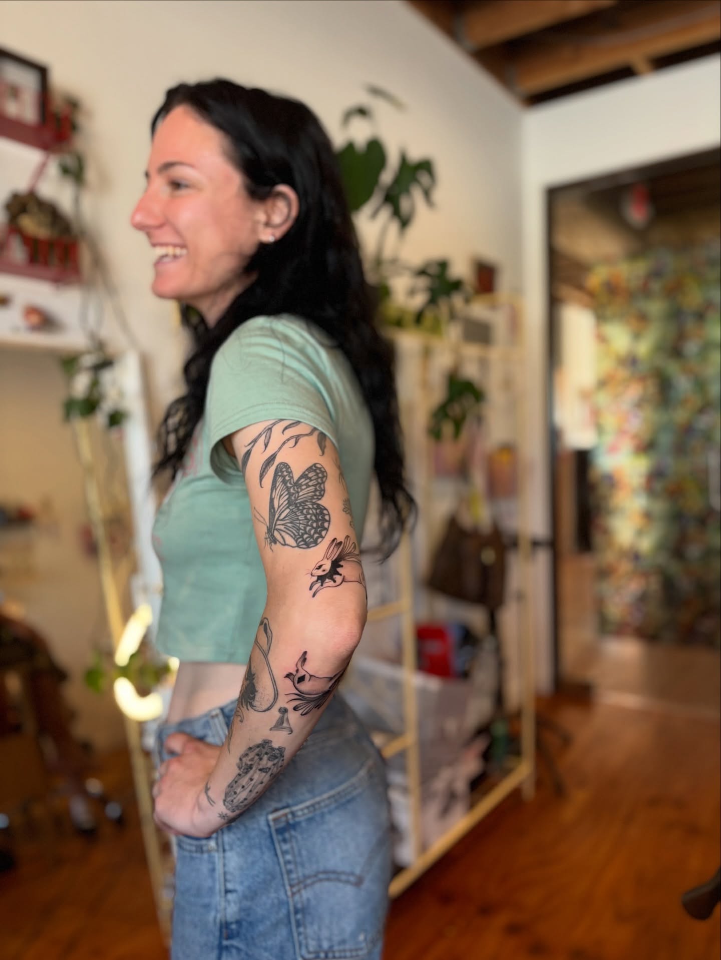 Butterfly and rabbit black and grey tattoo on the forearm by carla sofia