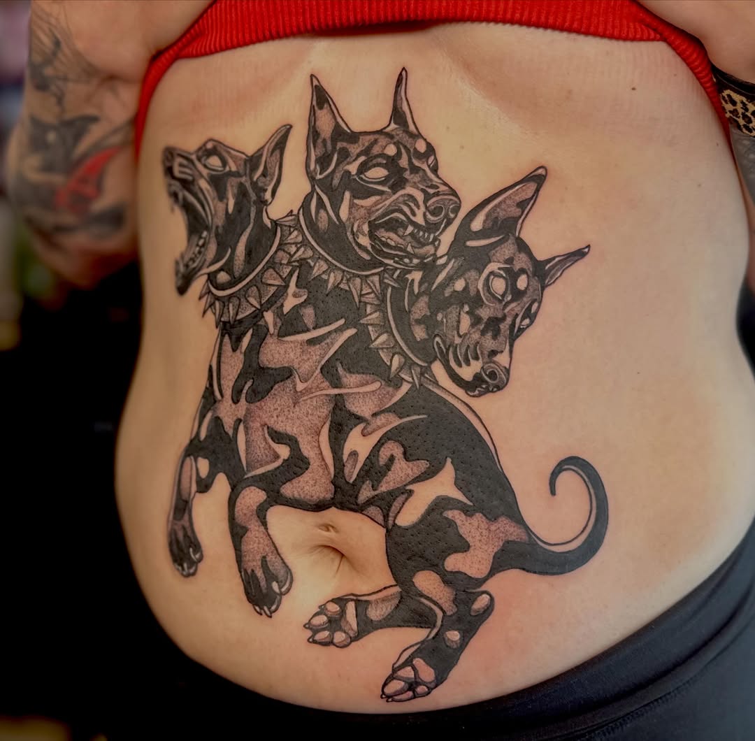 Three dogs tribal tattoo on the ribs by Leeuh Vandever