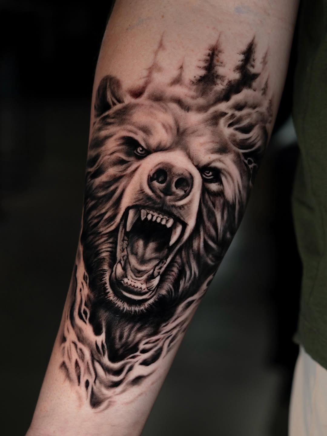 Roaring bear with trees realism tattoo on the forearm by Charlotte Tattoo Artist