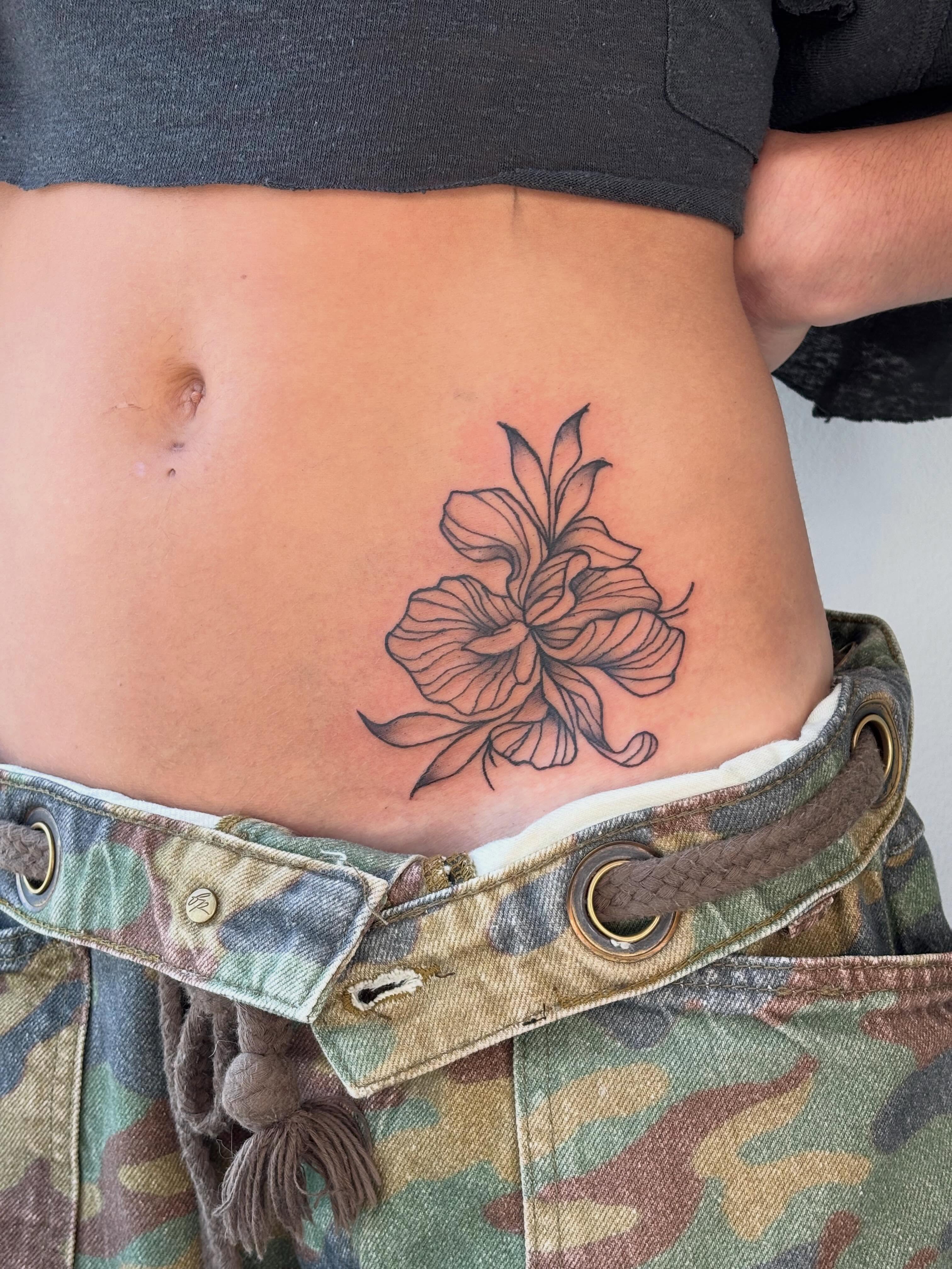 Flower black and grey tattoo on the torso by Topher Belmont