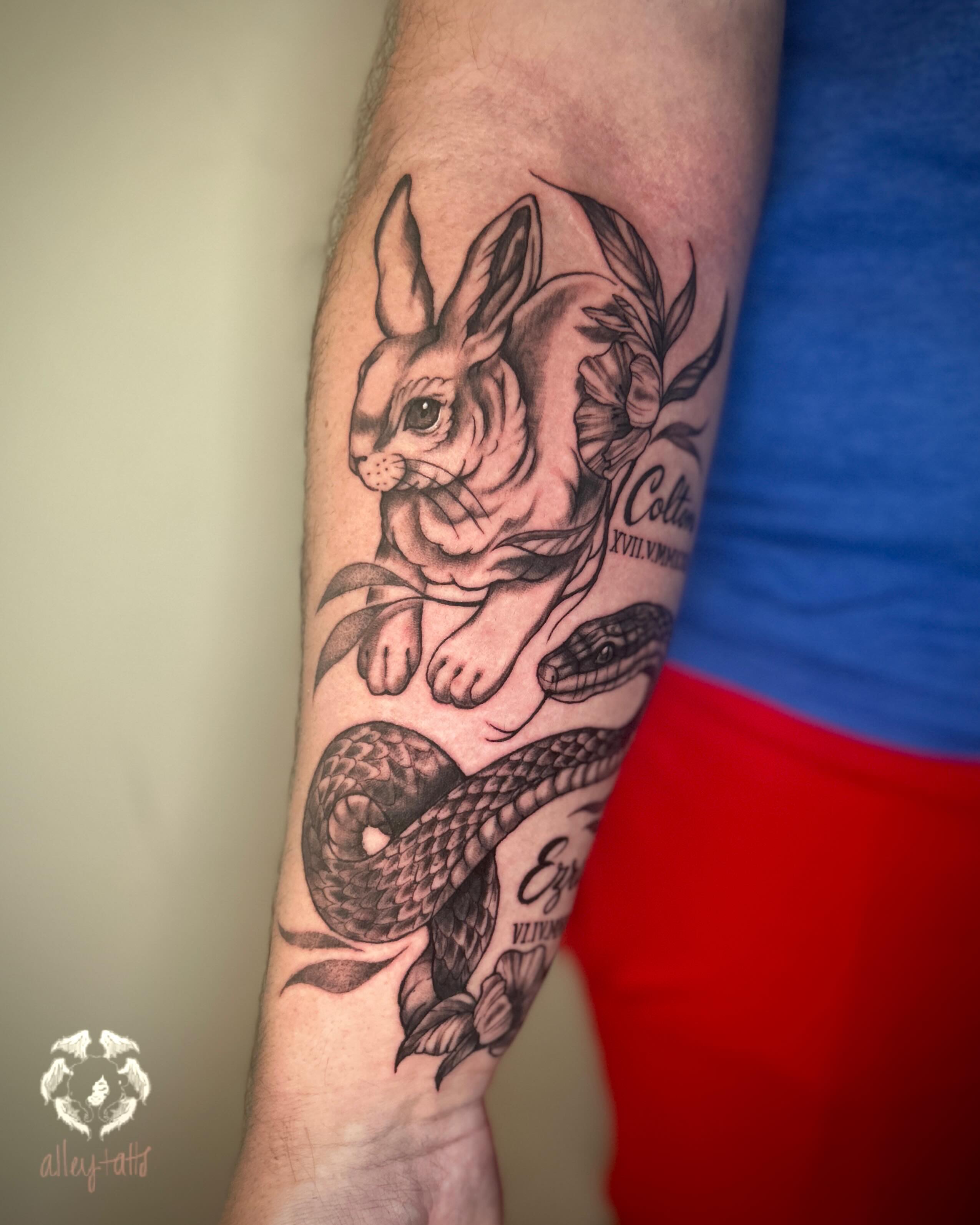 Rabbit and snake black and grey tattoo on the forearm by Alex