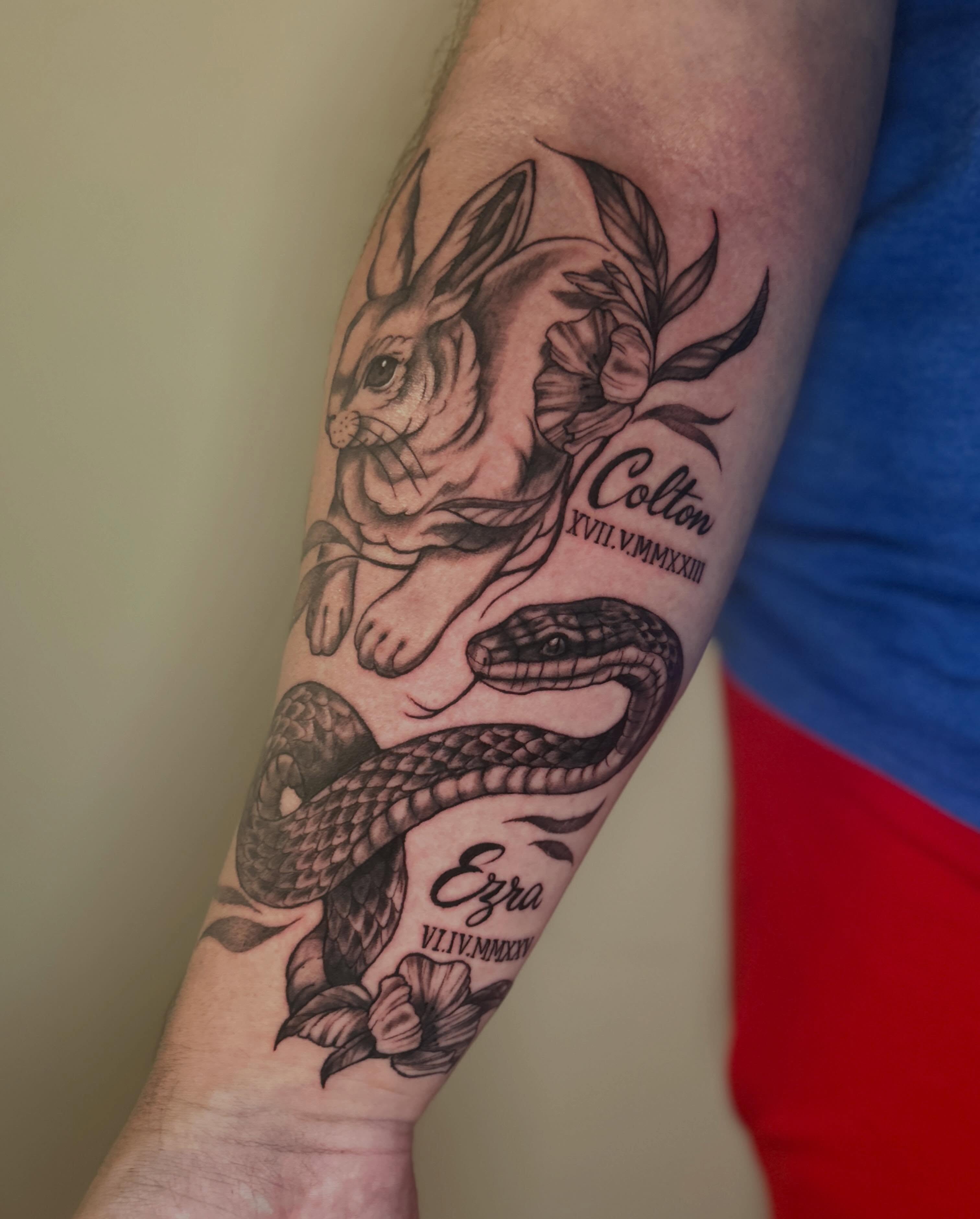 Rabbit and snake realism tattoo on the forearm by Alex