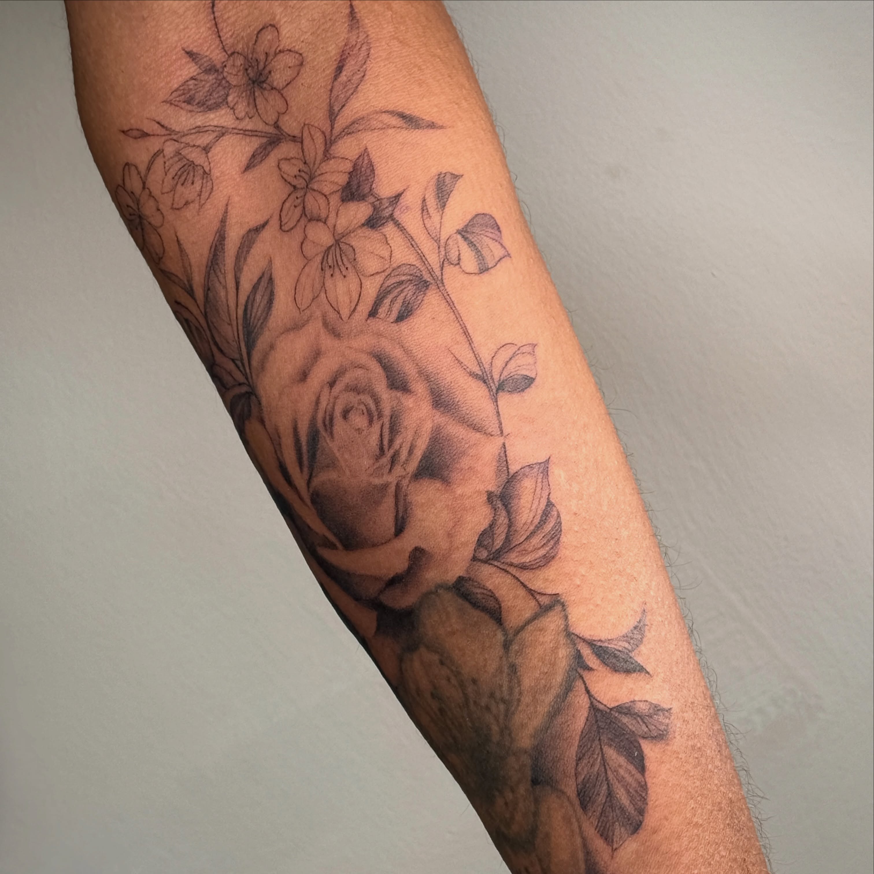 Floral bouquet black and grey tattoo on the forearm by 「 ✦ Sa-Na ✦ 」DMV TATTOO ARTIST
