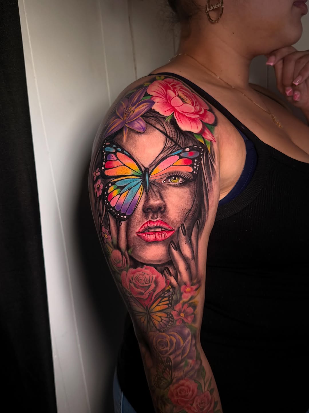 Woman's face with butterfly and flowers surrealism tattoo on the shoulder by Nj Tattoo Artist Inkdyou, Bloomfield, New Jersey