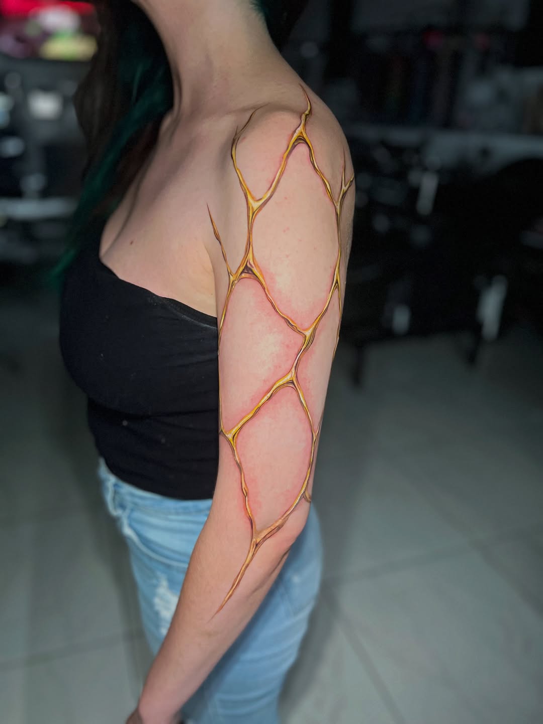Cracked skin texture cyber sigilism tattoo on the upper arm by Bay Area Tattoo Artist