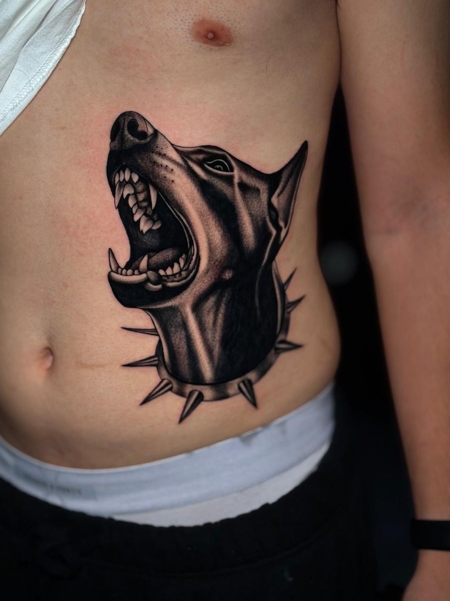 Roaring dog black and grey tattoo on the ribs by Exis LHinc, Miami, Florida