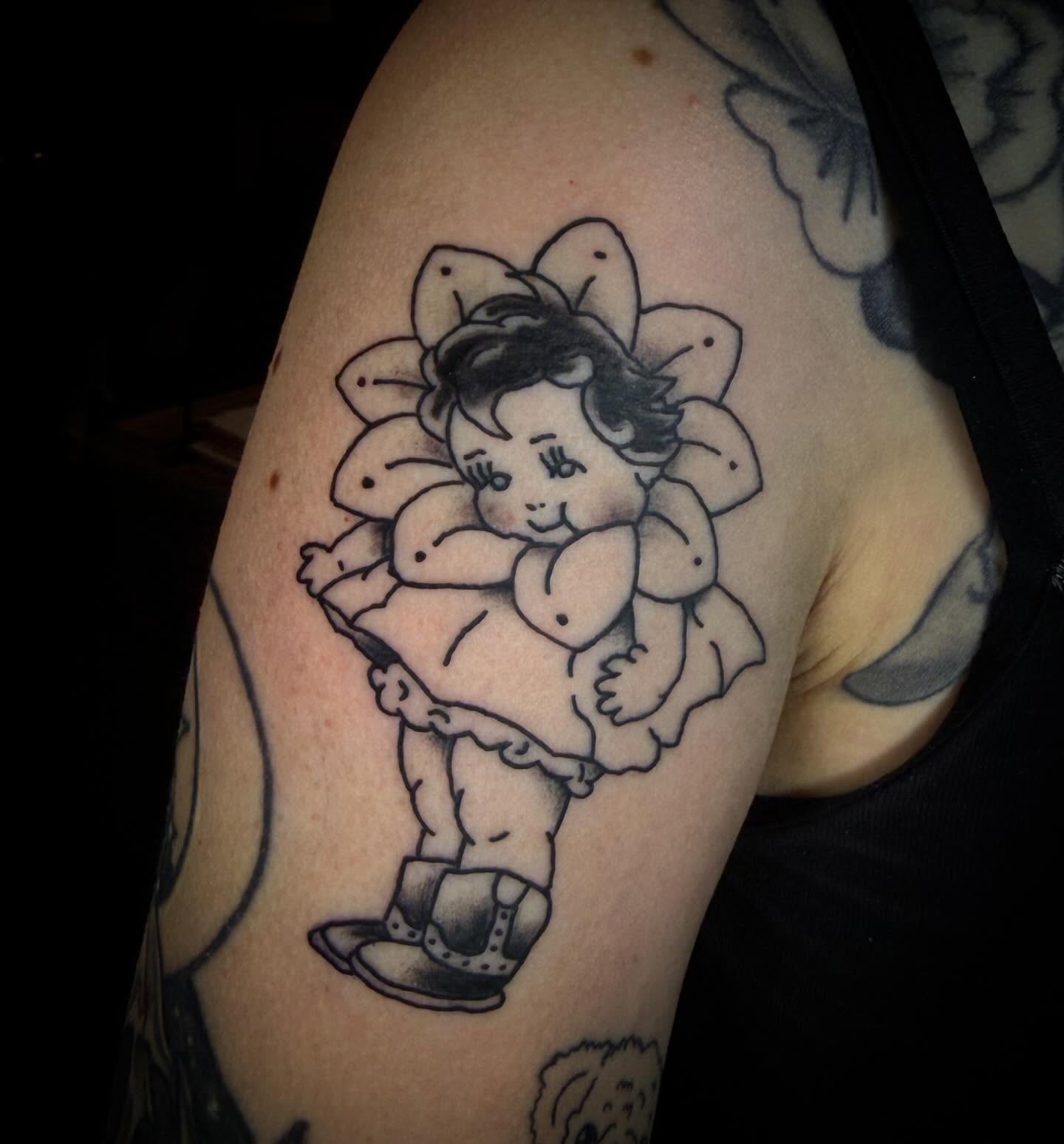 Child with flower black and grey tattoo on the shoulder by Tatts By Bryan B 🇲🇽 - SLC