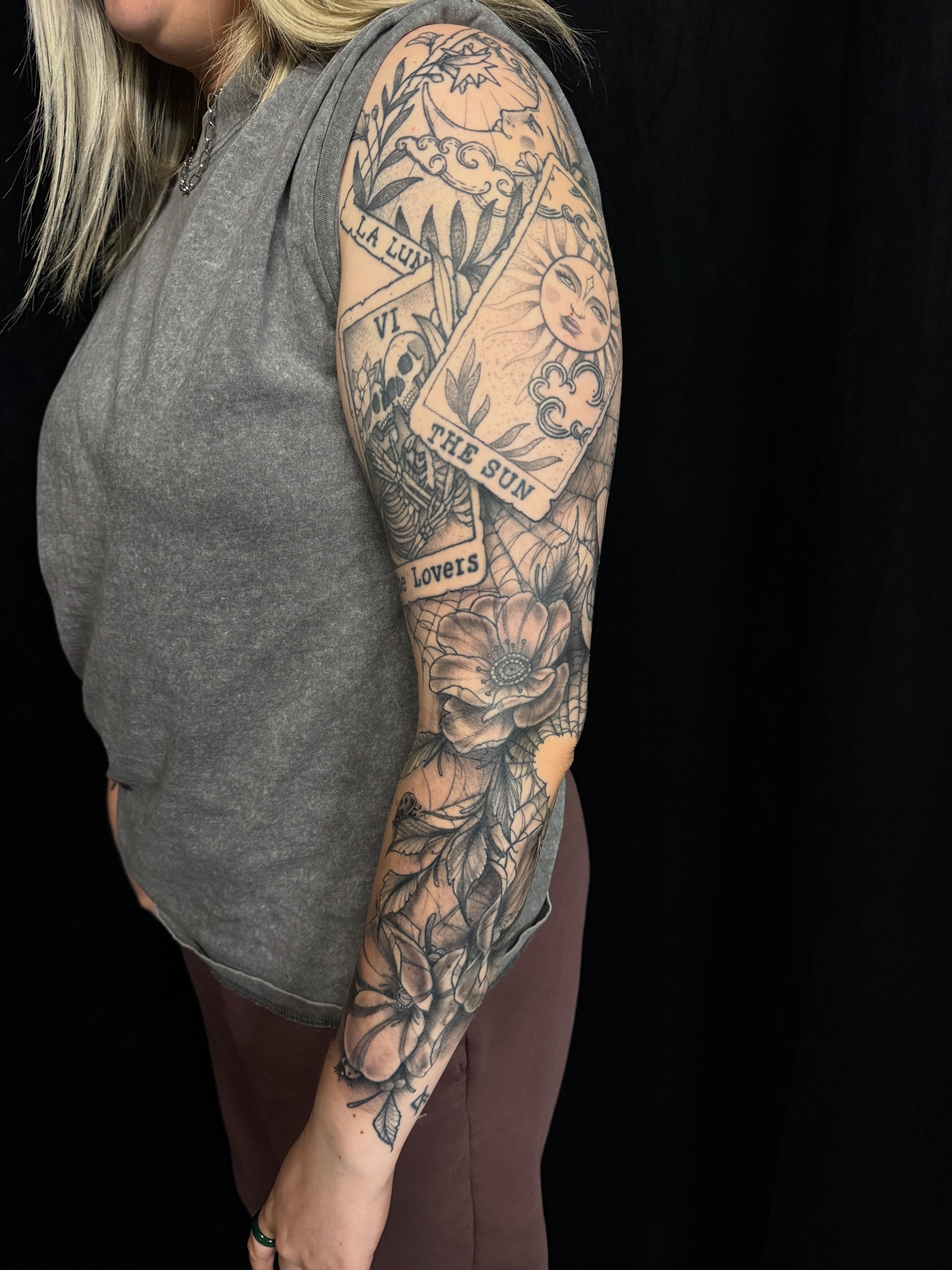 Sun card and floral black and grey tattoo on the forearm by Will McCoy (Tattooist), Murray, Utah