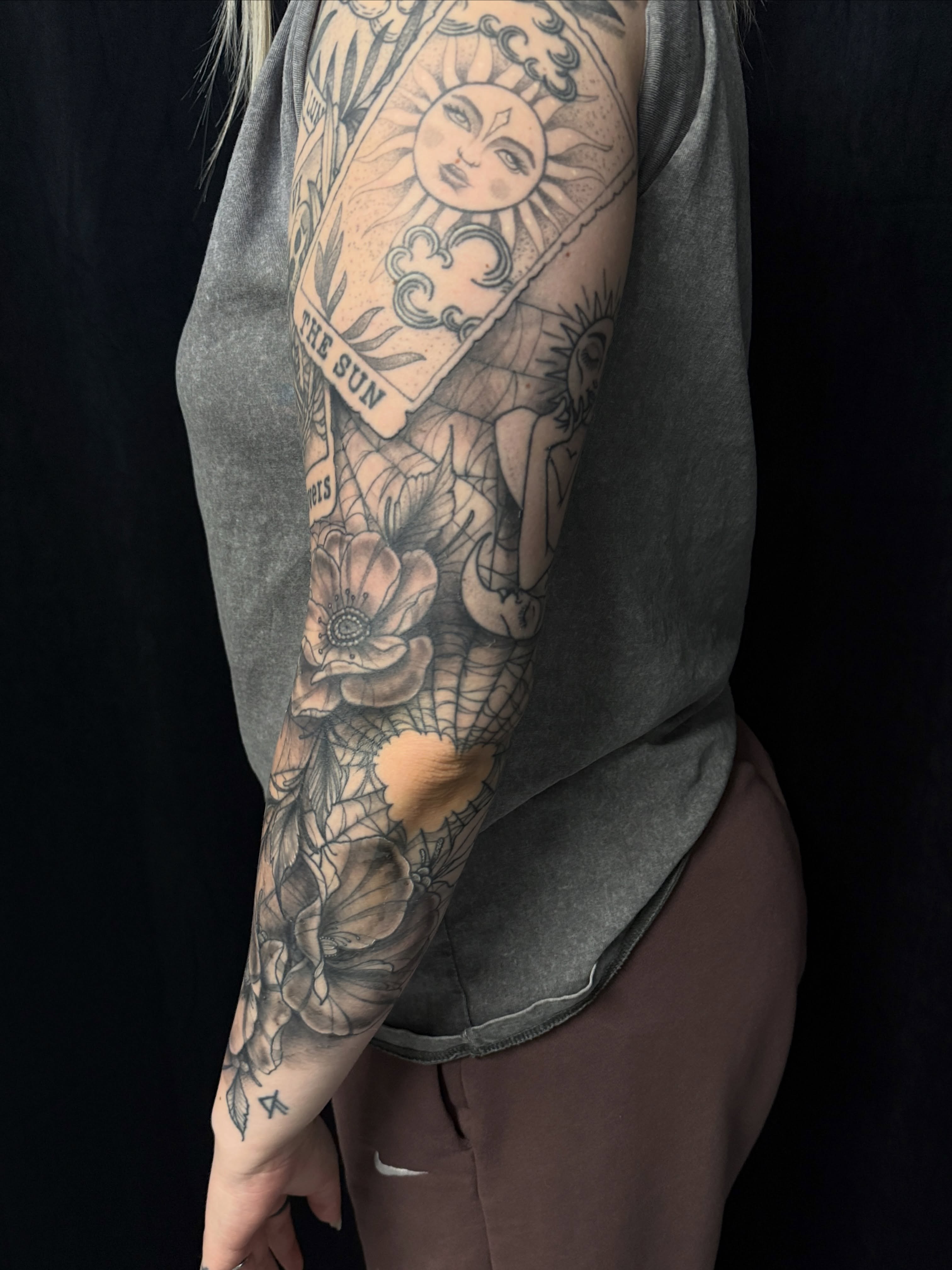 Sun card and floral realism tattoo on the forearm by Will McCoy (Tattooist), Murray, Utah