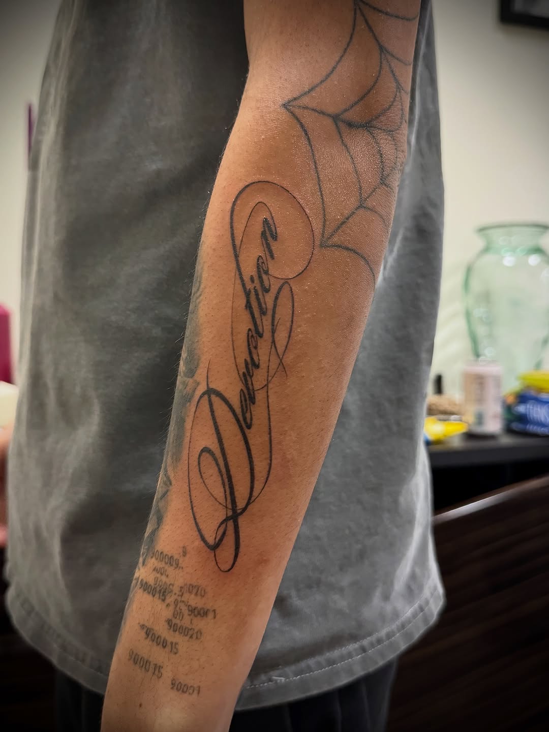 Lettering tattoo on the forearm by Ava De La Torre