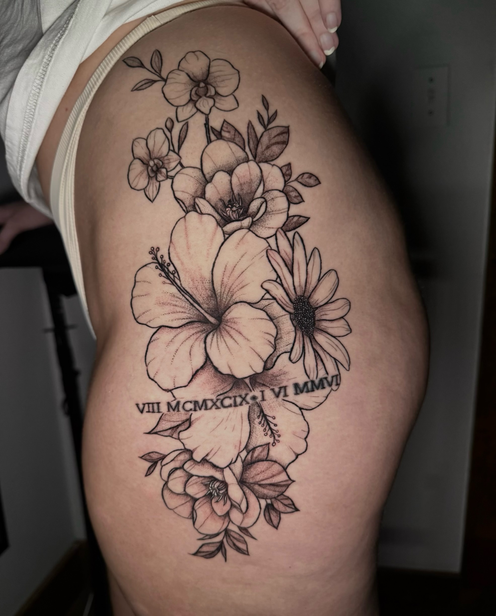 Floral bouquet black and grey tattoo on the thigh by Shay - Mandeville Tattoo Artist