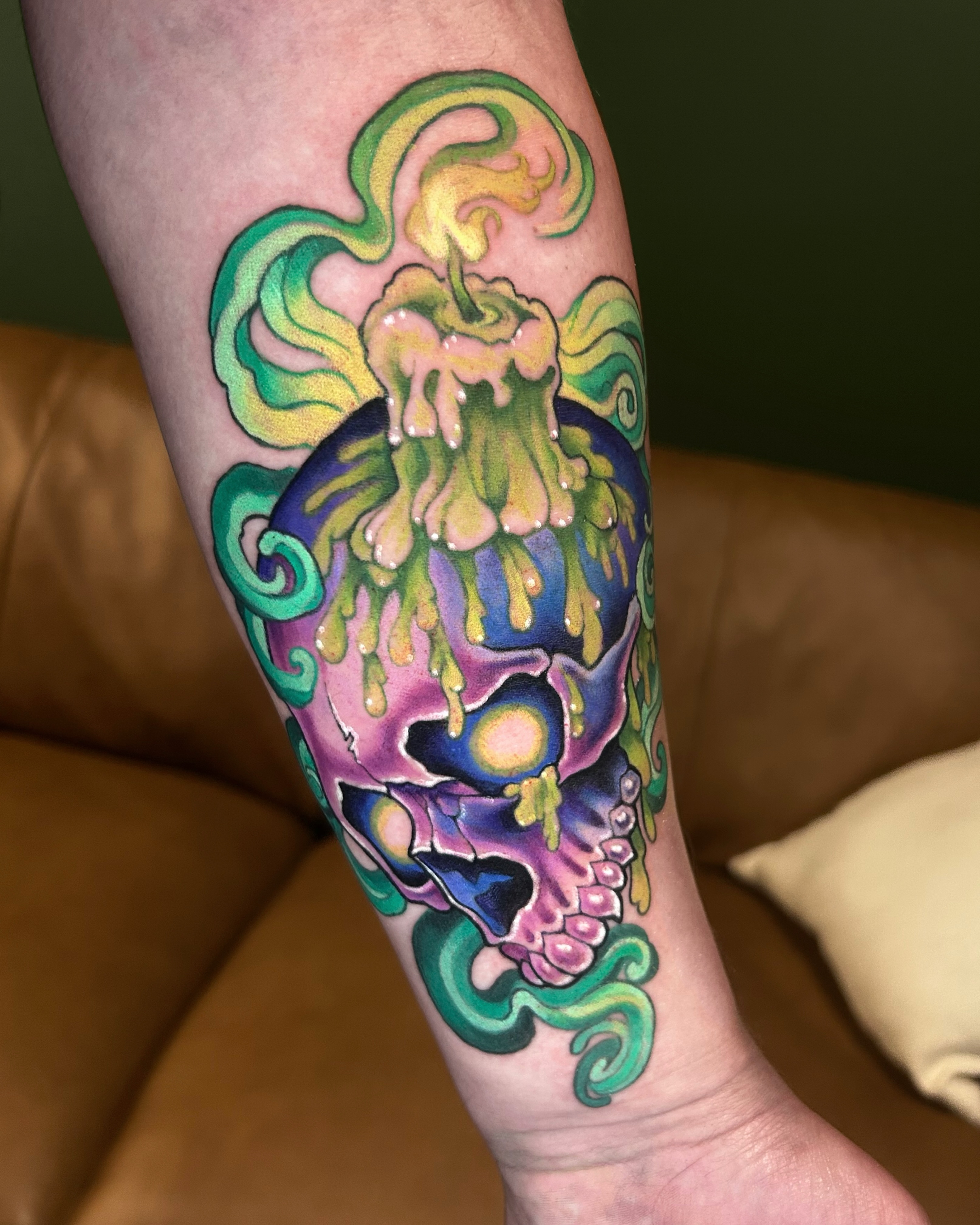 Skull with candle new school tattoo on the forearm by Zephyr